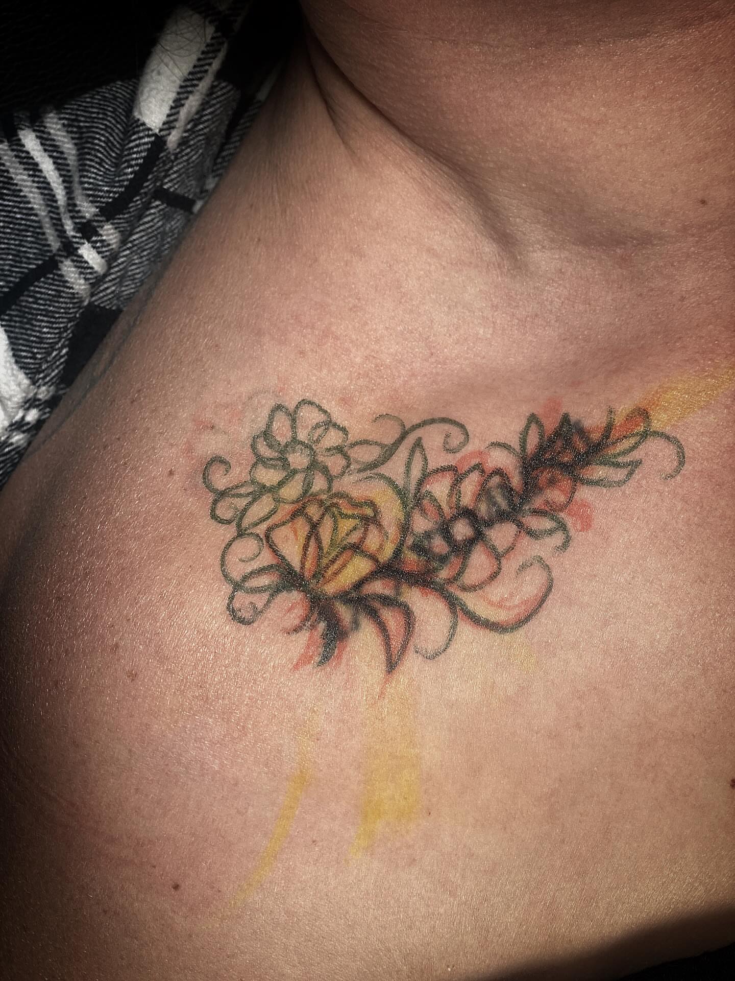Floral arrangement watercolor tattoo on the chest by Chris Klee