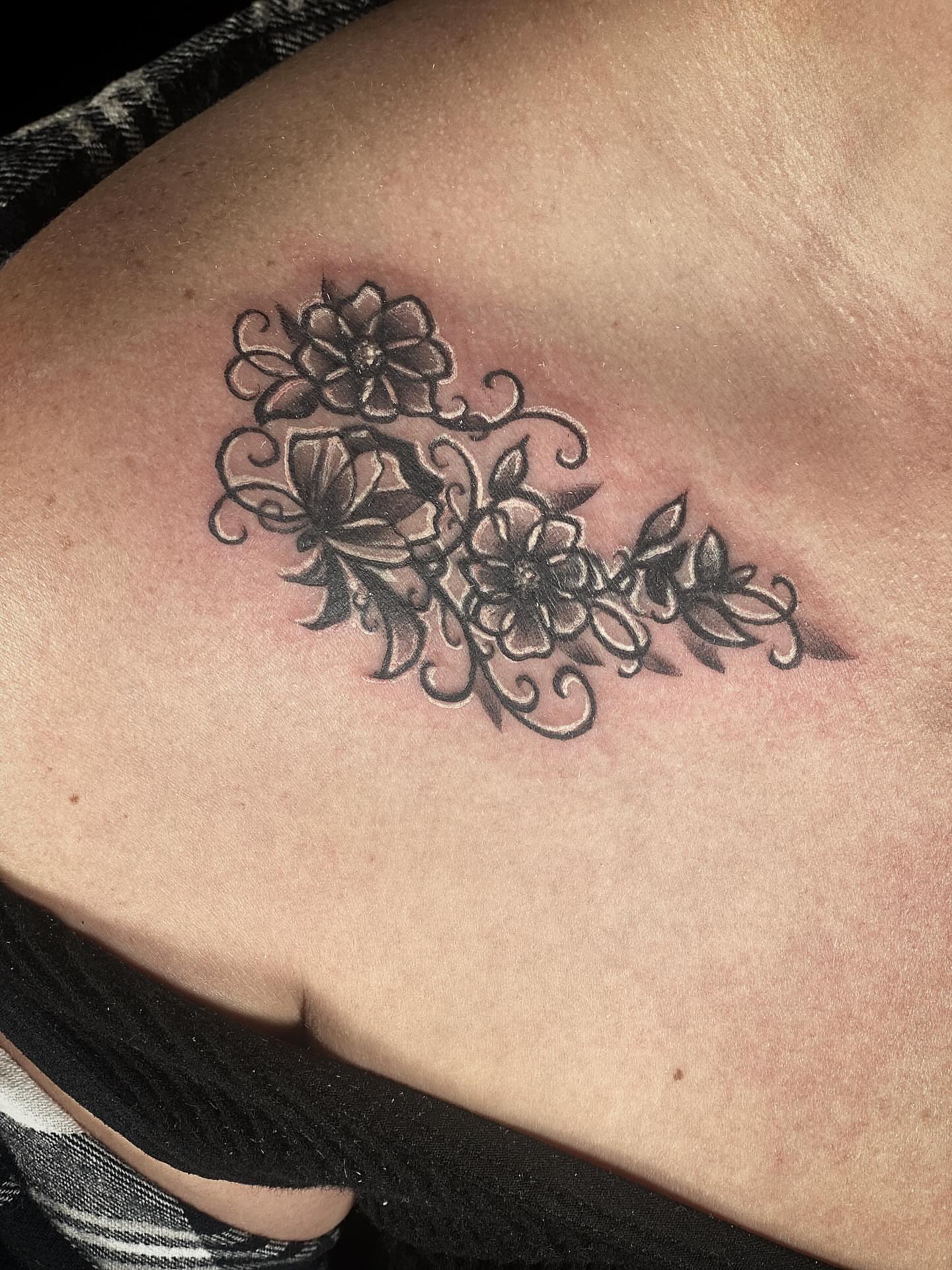 Floral bouquet black and grey tattoo on the shoulder by Chris Klee