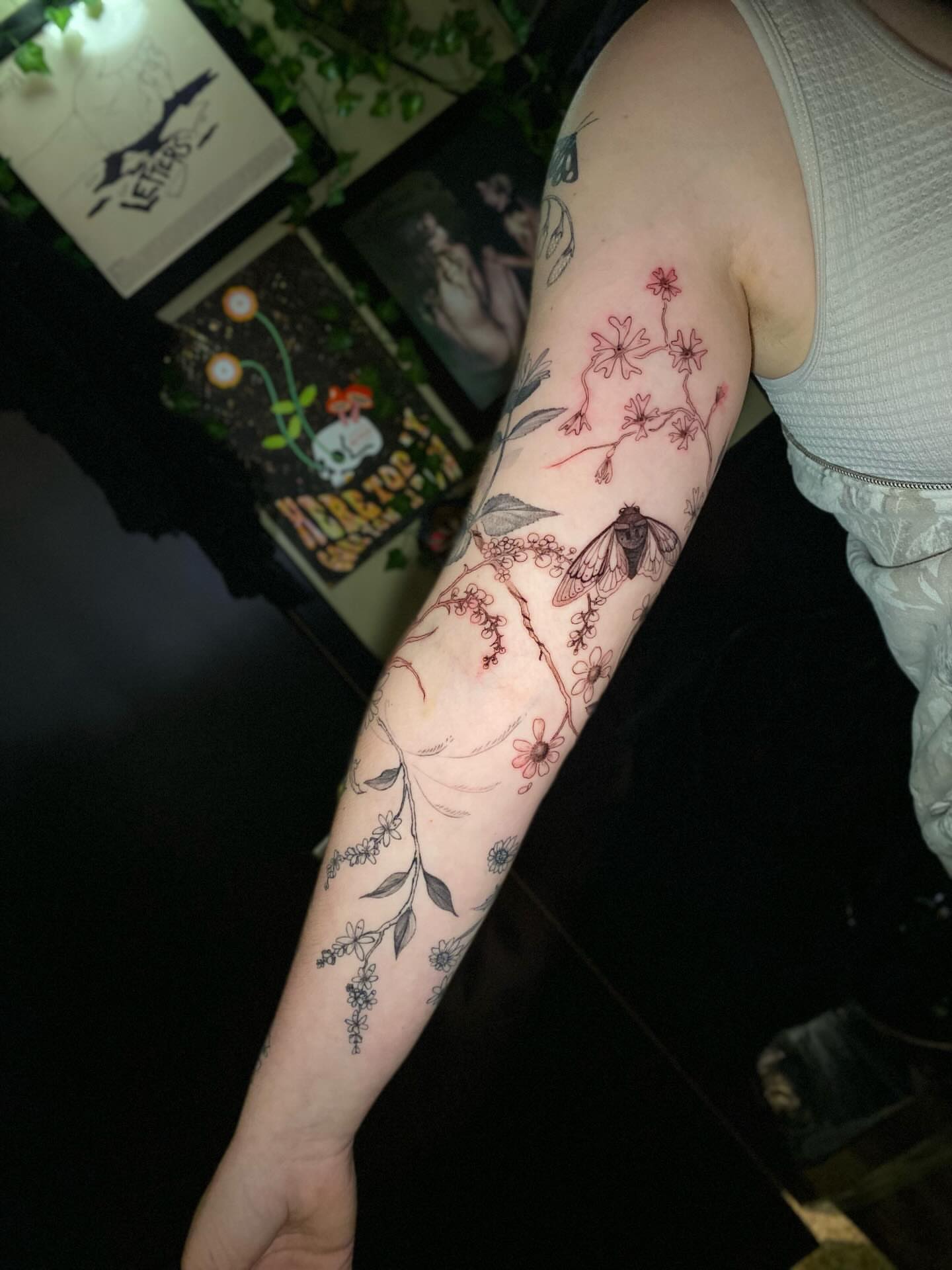 Insect and floral black and grey tattoo on the forearm by Olivia Scott - Kansas Tattoo Artist