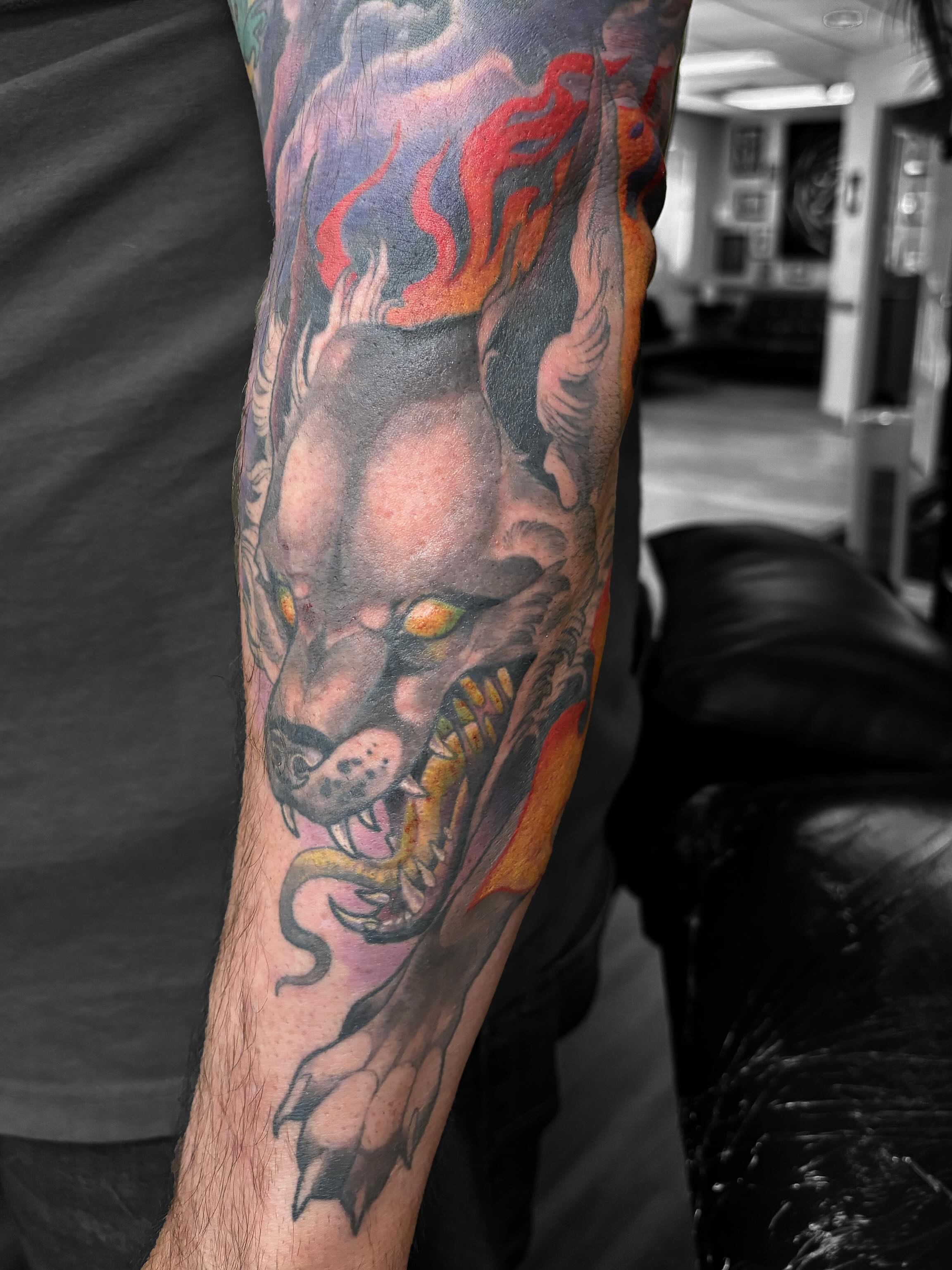 Demon head with snake American traditional tattoo on the forearm by Alex