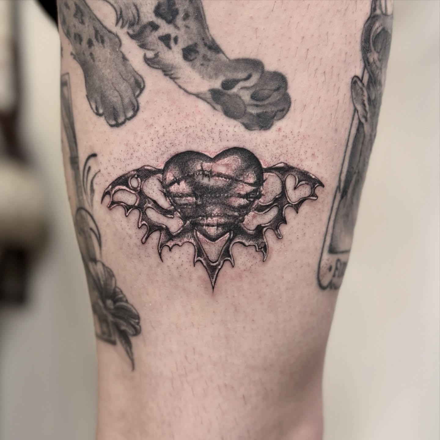 Heart with bat wings geometric tattoo on the forearm by Andy Rowe- Tattoo Artist🦇