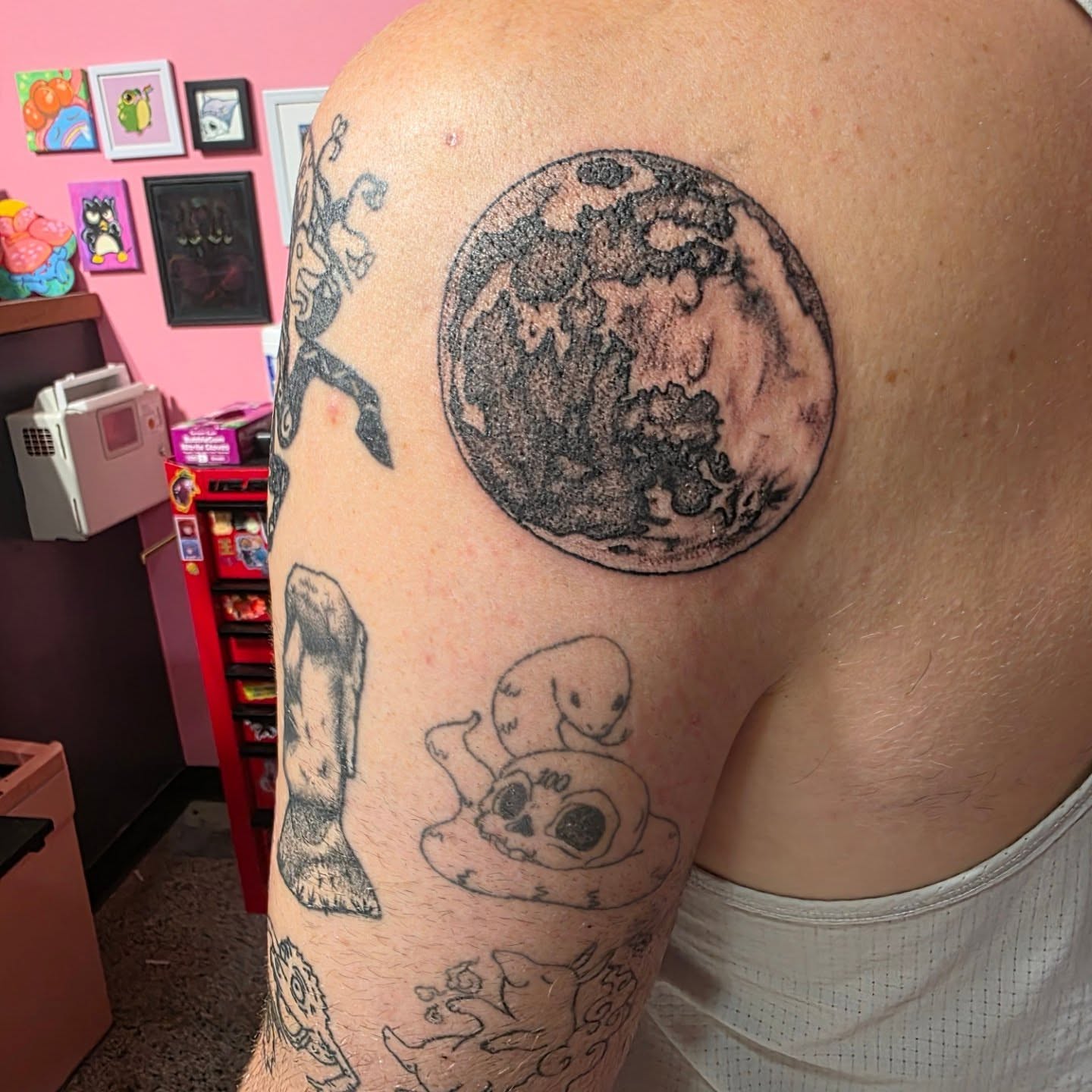 Earth black and grey tattoo on the shoulder by K.F. Golden