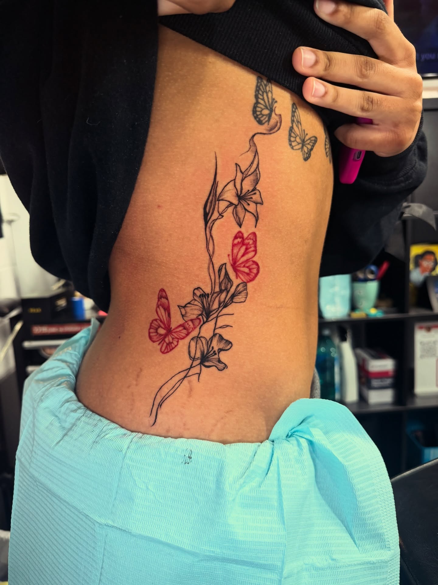 Butterflies and flowers new school tattoo on the ribs by CandiCoatedInk