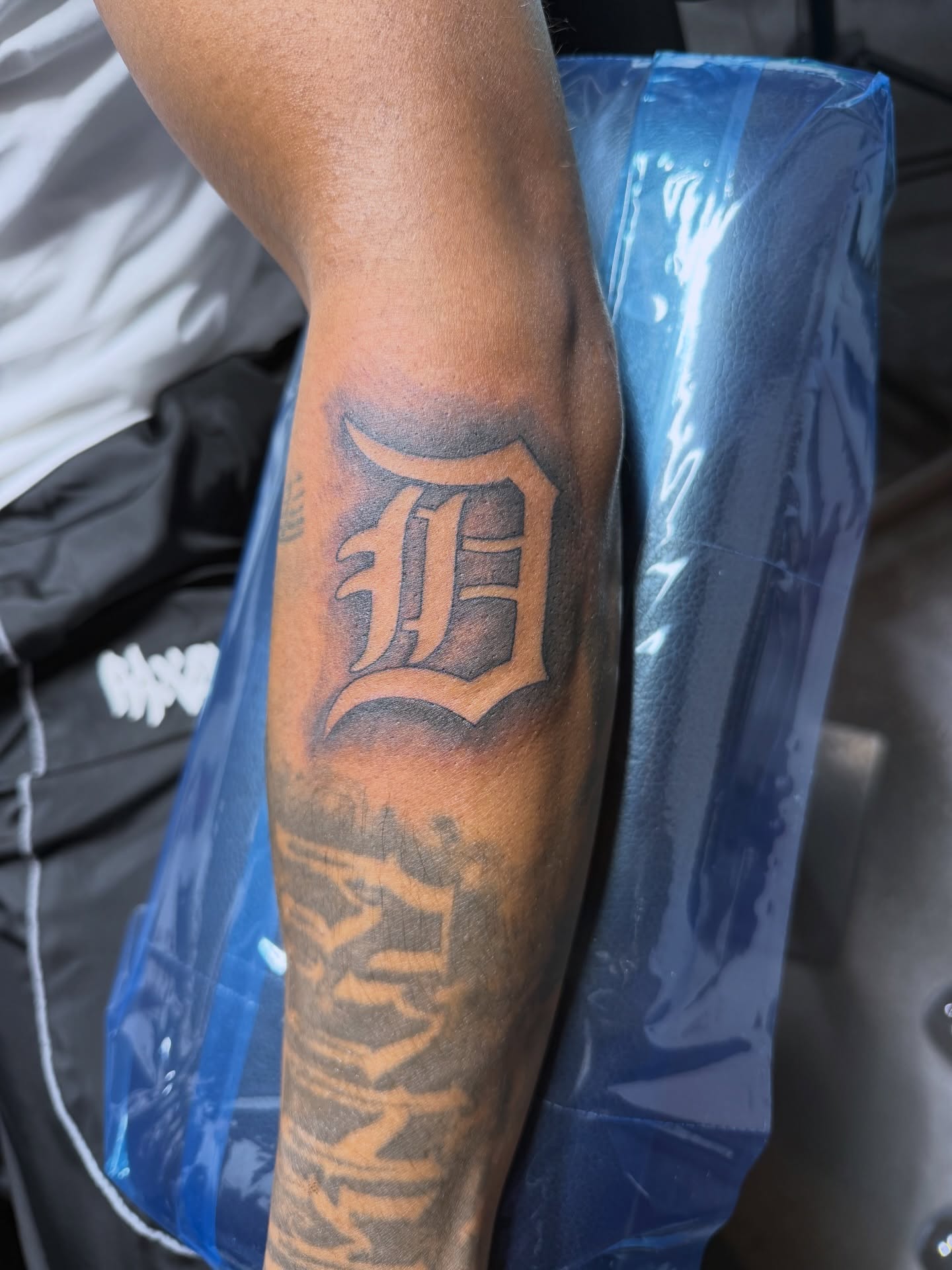 Letter D black and grey tattoo on the forearm by CandiCoatedInk