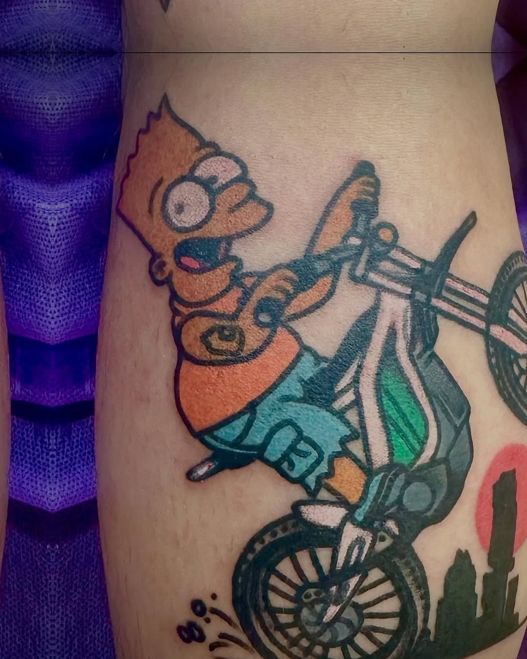 Bart Simpson on a bicycle new school tattoo on the thigh by Jaquelin Miller