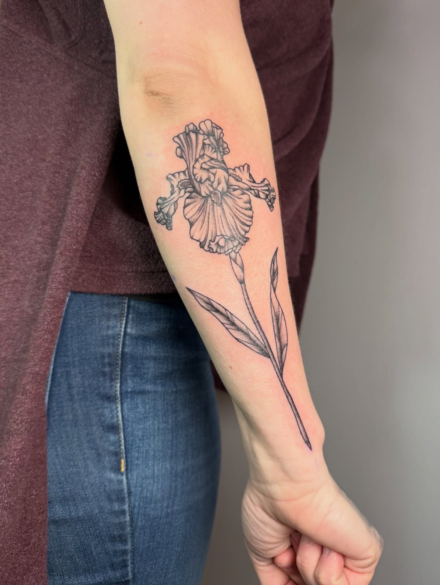 Iris black and grey tattoo on the forearm by Jenna Nicole