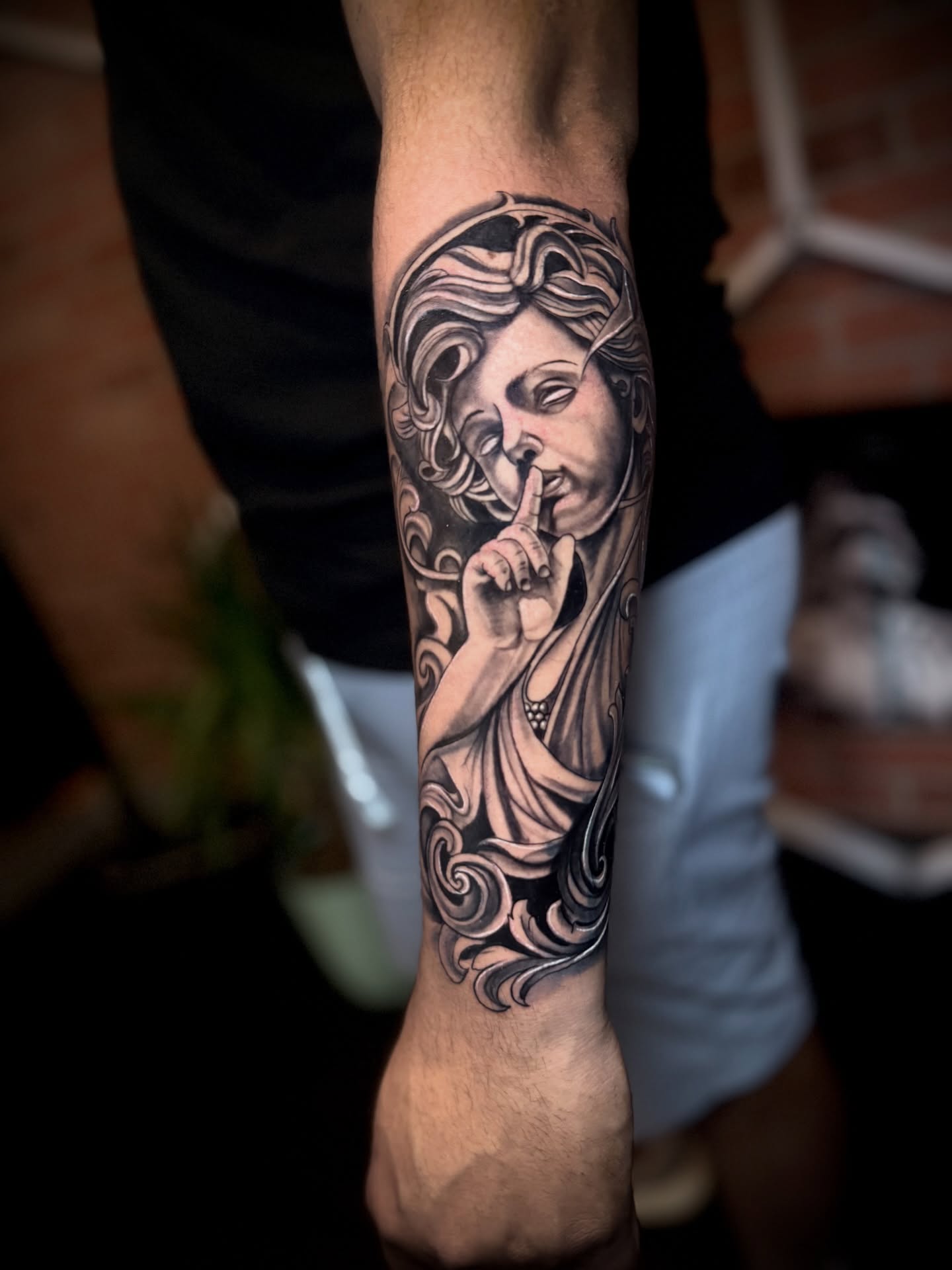 Statue with finger on lips realism tattoo on the forearm by Andres Calvo🇺🇸🇨🇴