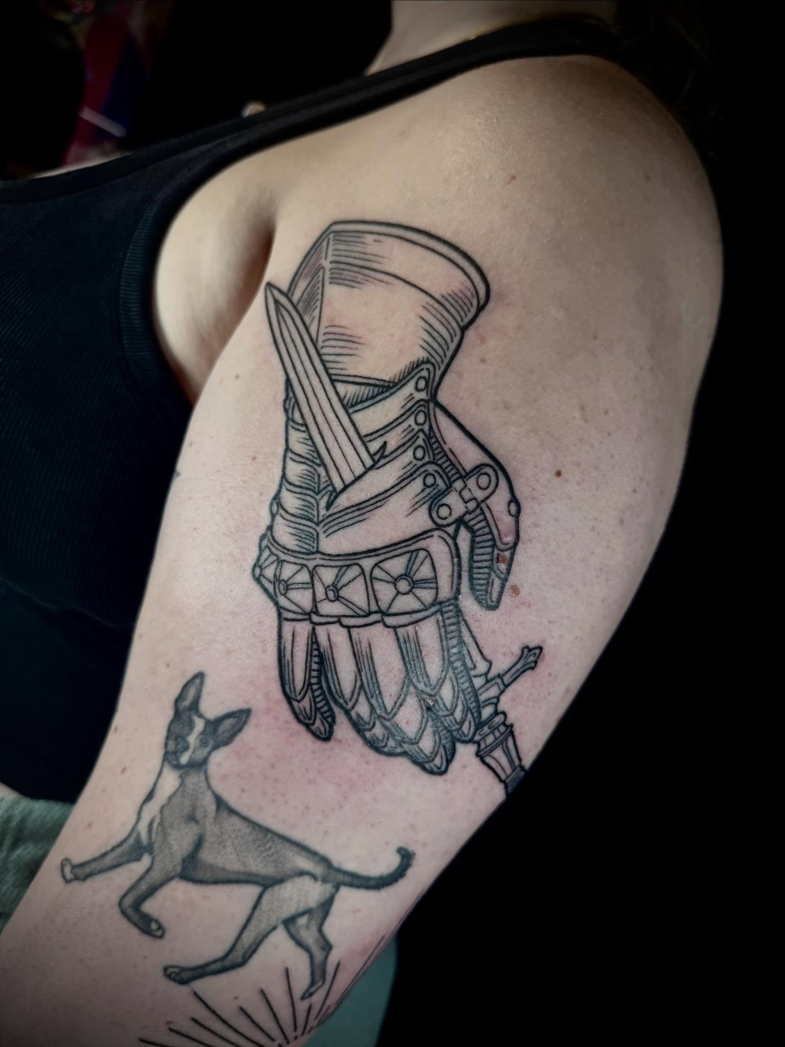 Knight and dog black and grey tattoo on the upper arm by 🏵