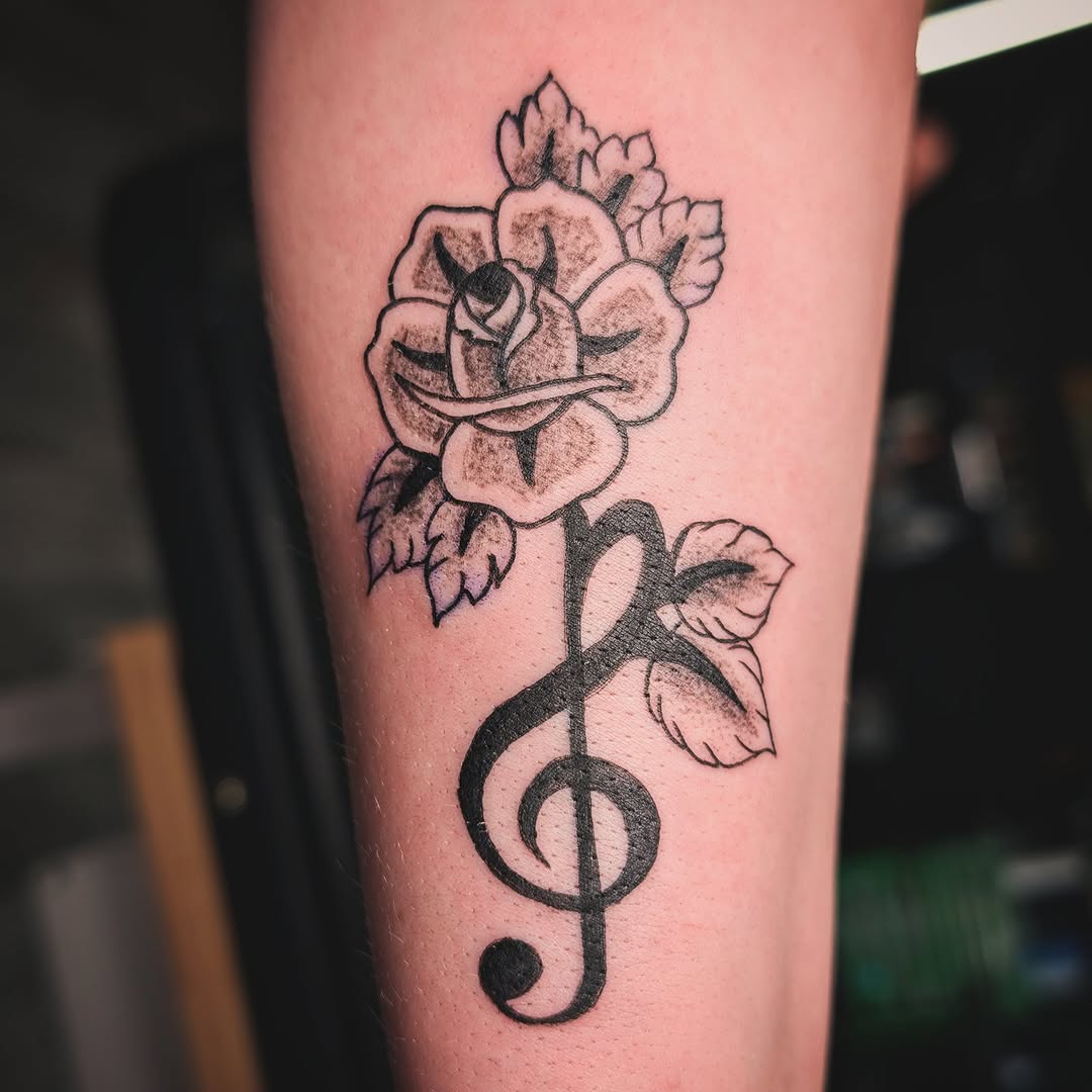 Rose and treble clef neo-traditional tattoo on the forearm by Matt Mahl