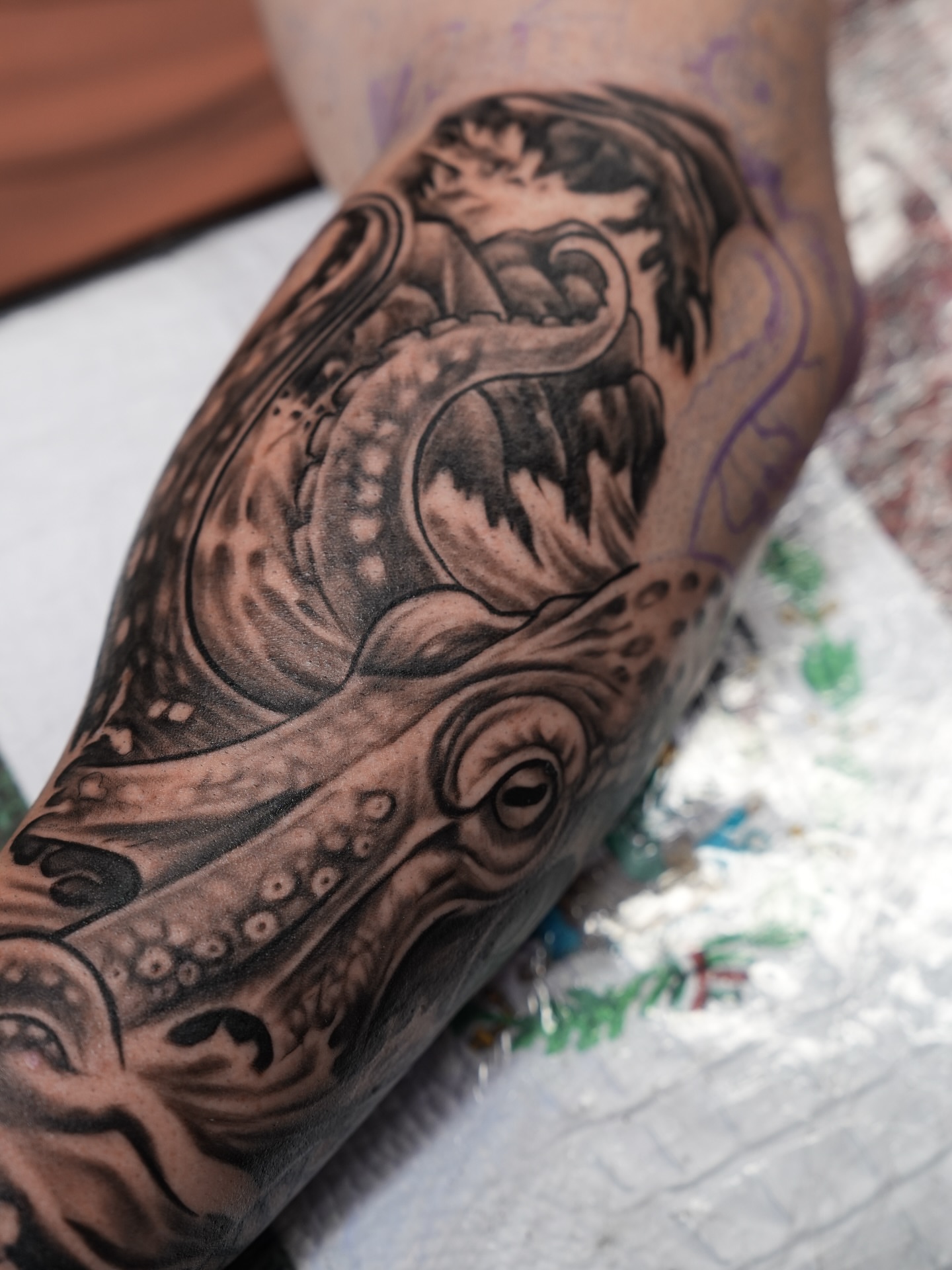 Squid and boy realism tattoo on the forearm by Kevin Betancourt