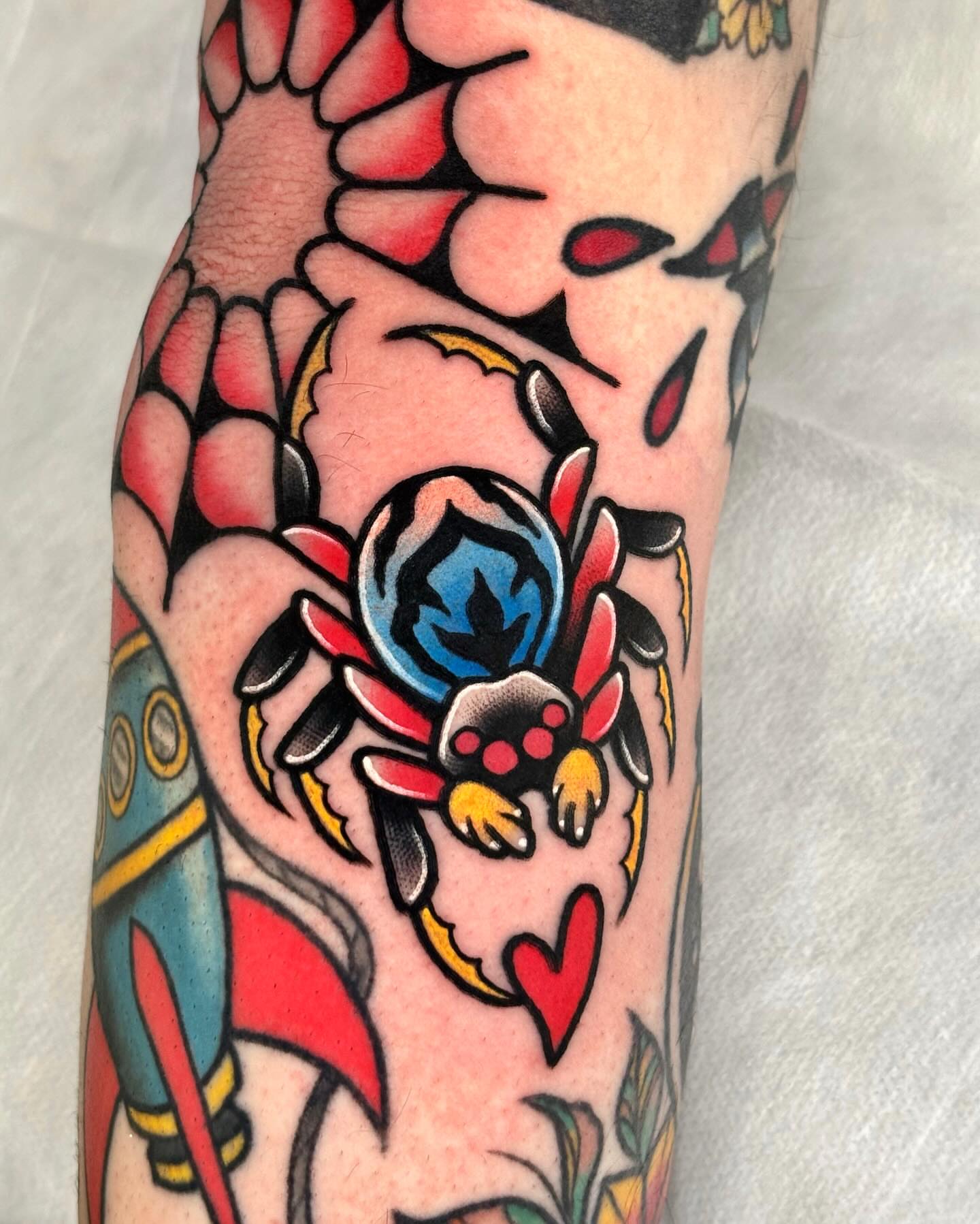 Spider and flower American traditional tattoo on the forearm by 부산타투