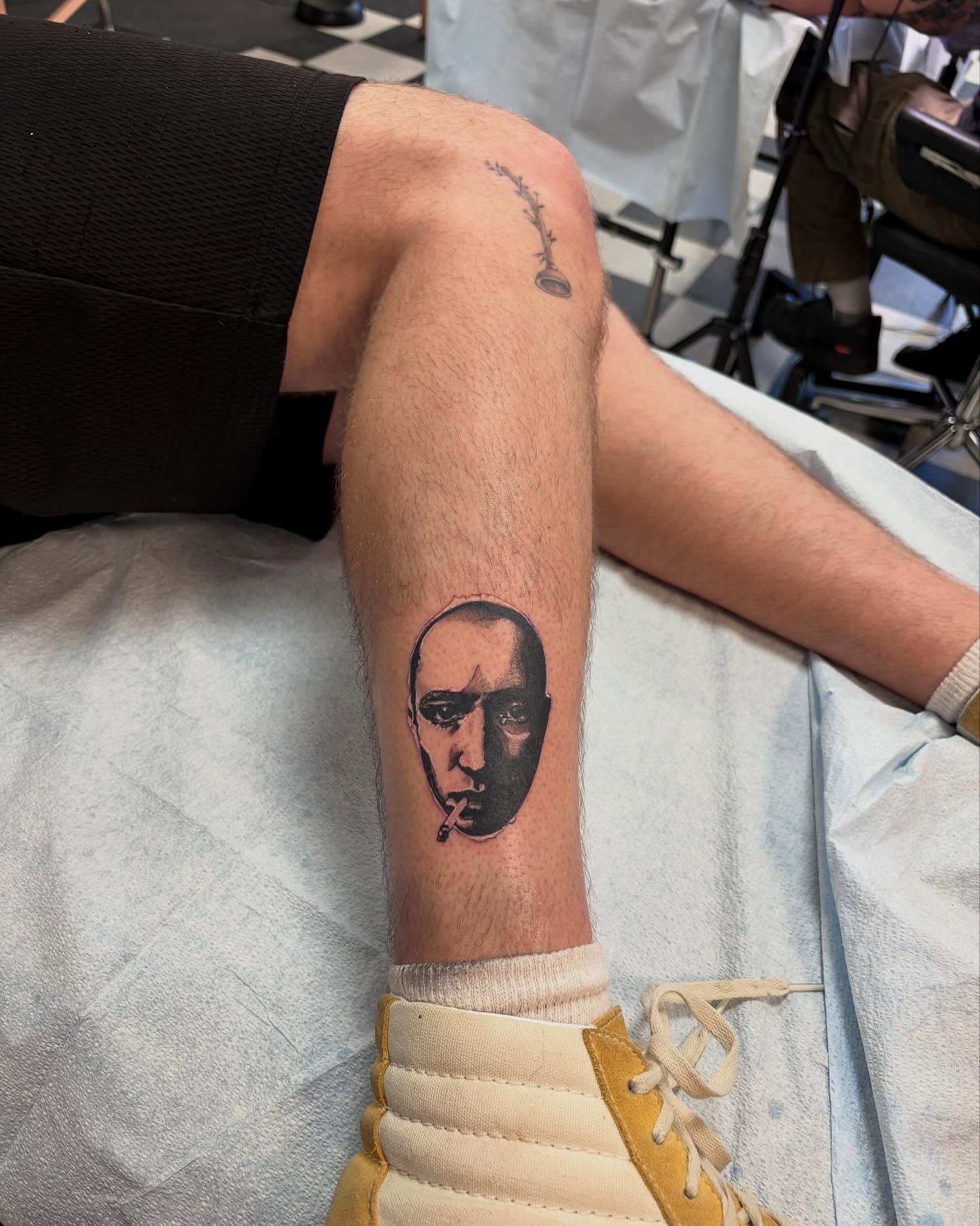 Smoking man realism tattoo on the forearm by Emily Falkowski