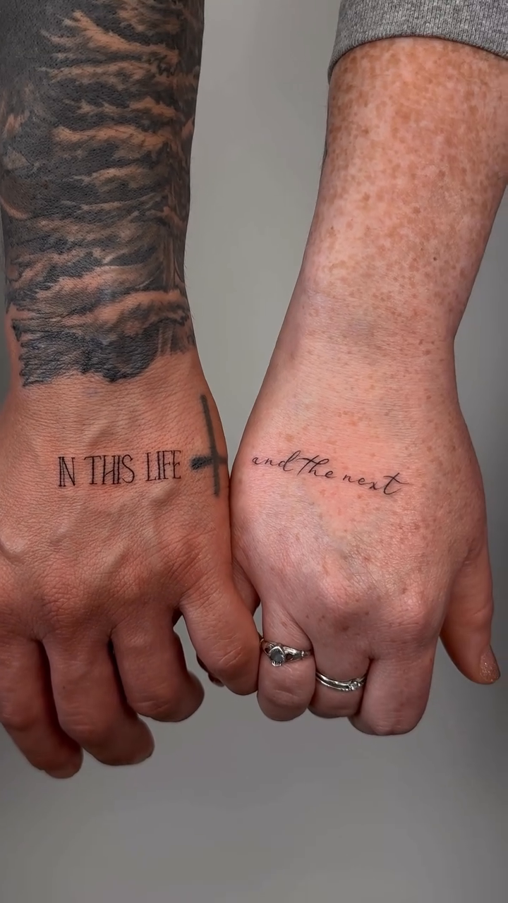Couple's matching hand tattoos lettering tattoo on the hand by Fine line tattoo