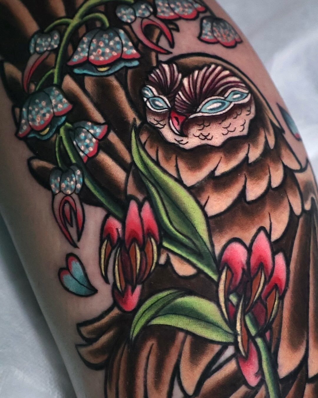 Owl and flowers American traditional tattoo on the forearm by Bailey Drey