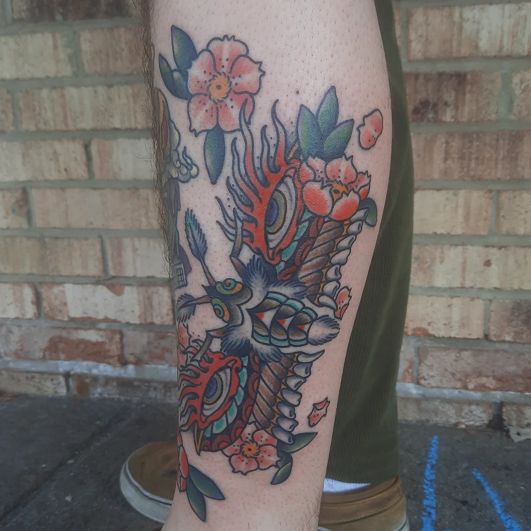 Bird and floral American traditional tattoo on the forearm by Kaetlyn