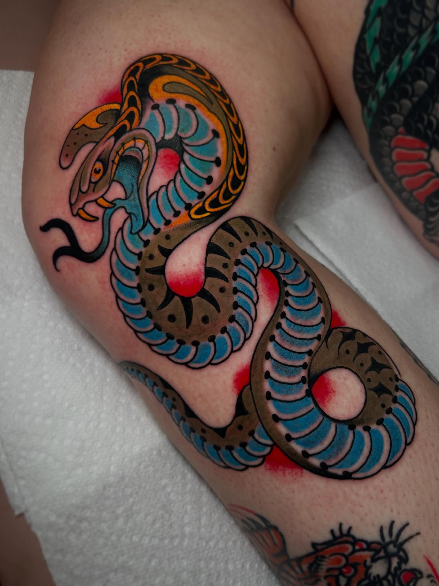 Snake American traditional tattoo on the thigh by Katie Dexter, Des Moines, Iowa