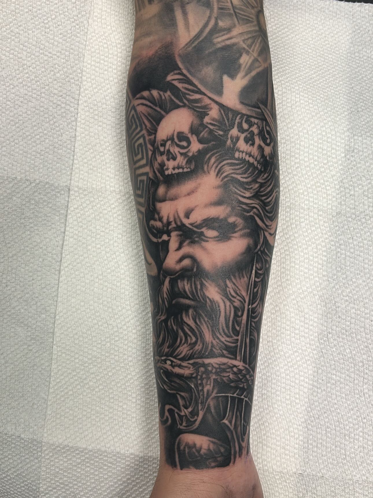 God-like figure realism tattoo on the forearm by Jesus Pubert Munster