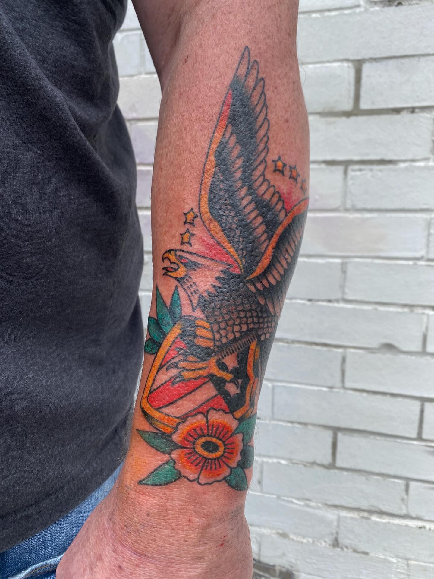 Eagle and flowers American traditional tattoo on the forearm by Abby Rose Estes