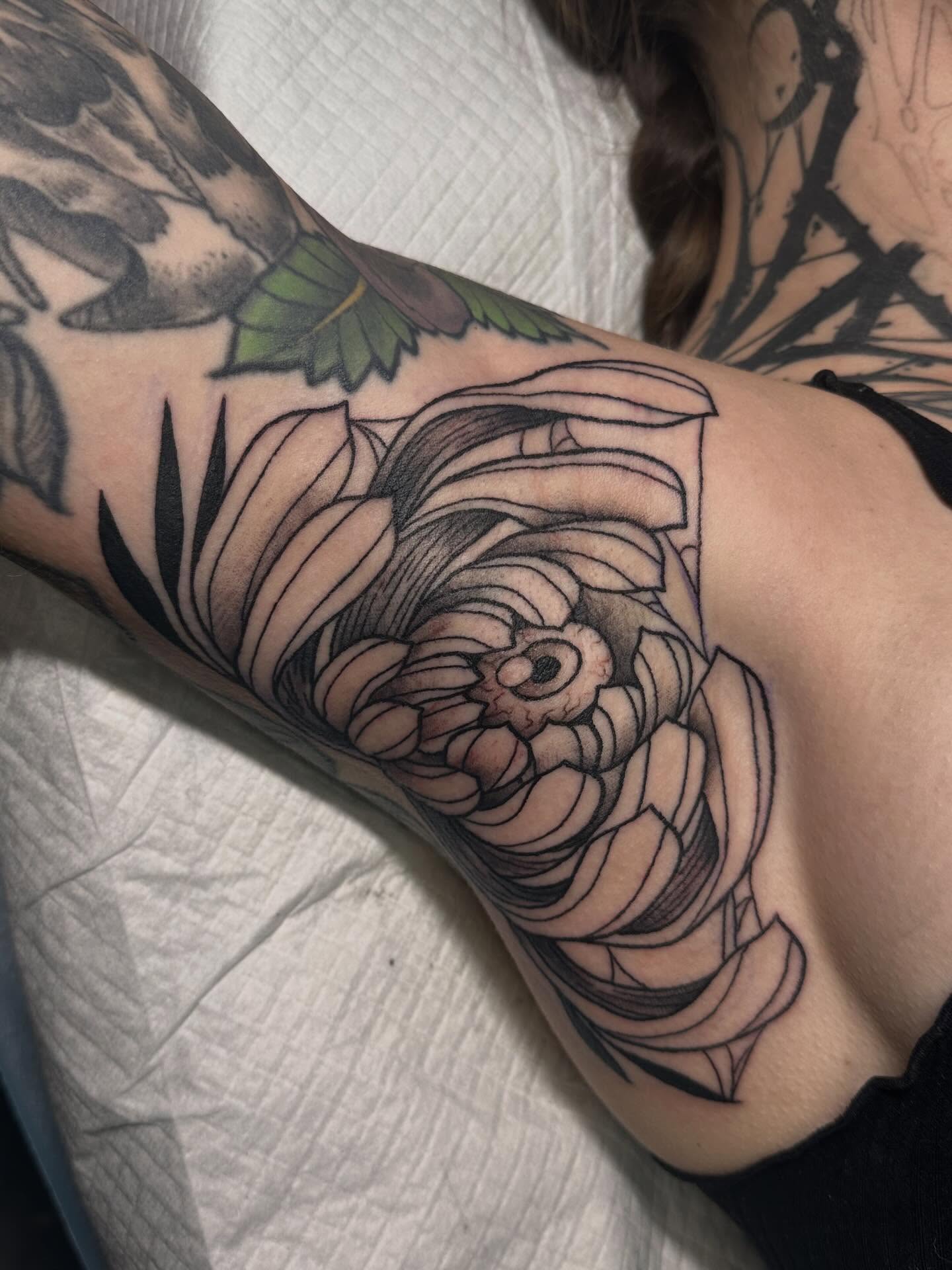 Flower black and grey tattoo on the forearm by Tattoo artist