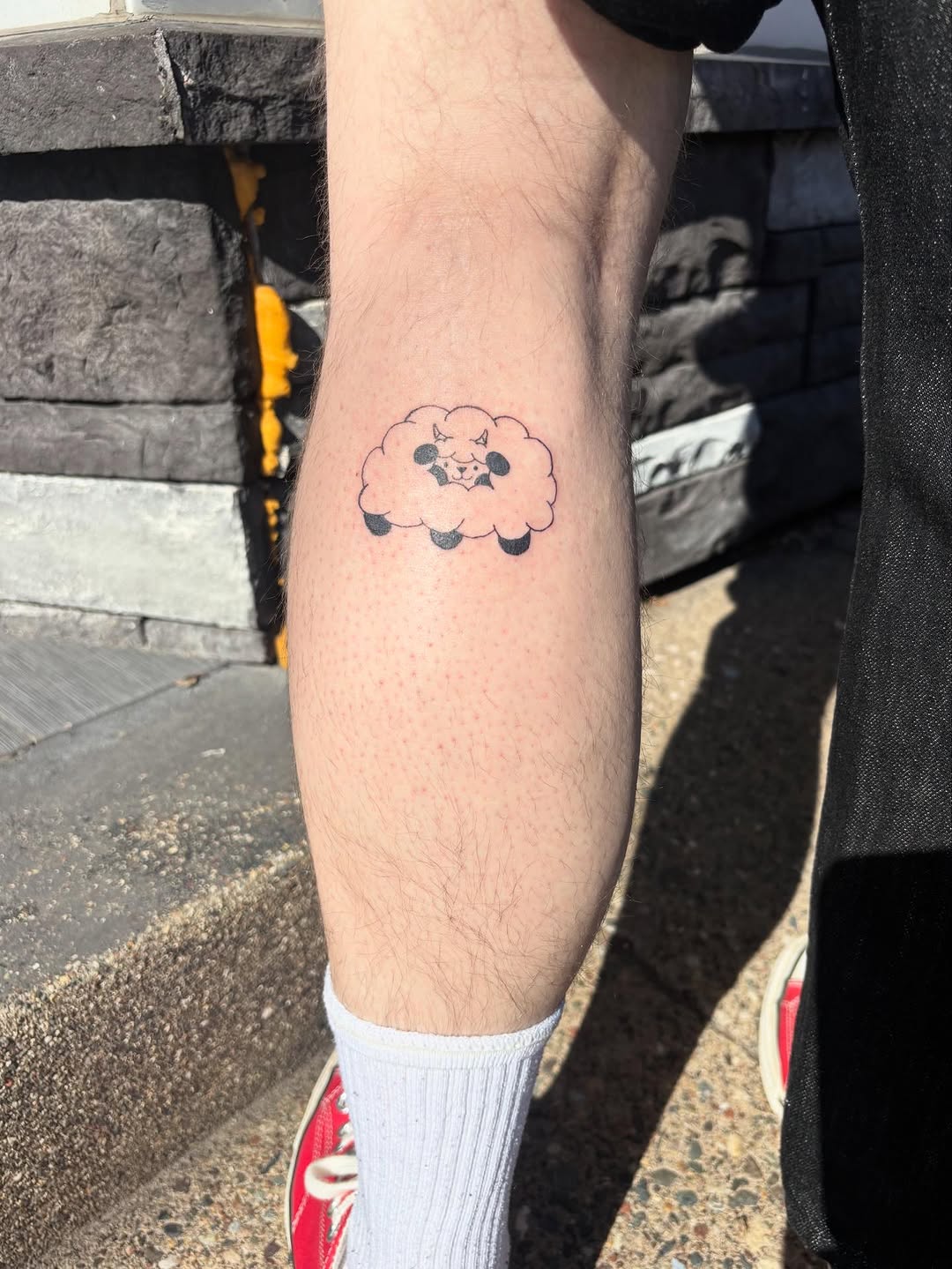 Fluffy sheep cloud ignorant tattoo on the forearm by riley