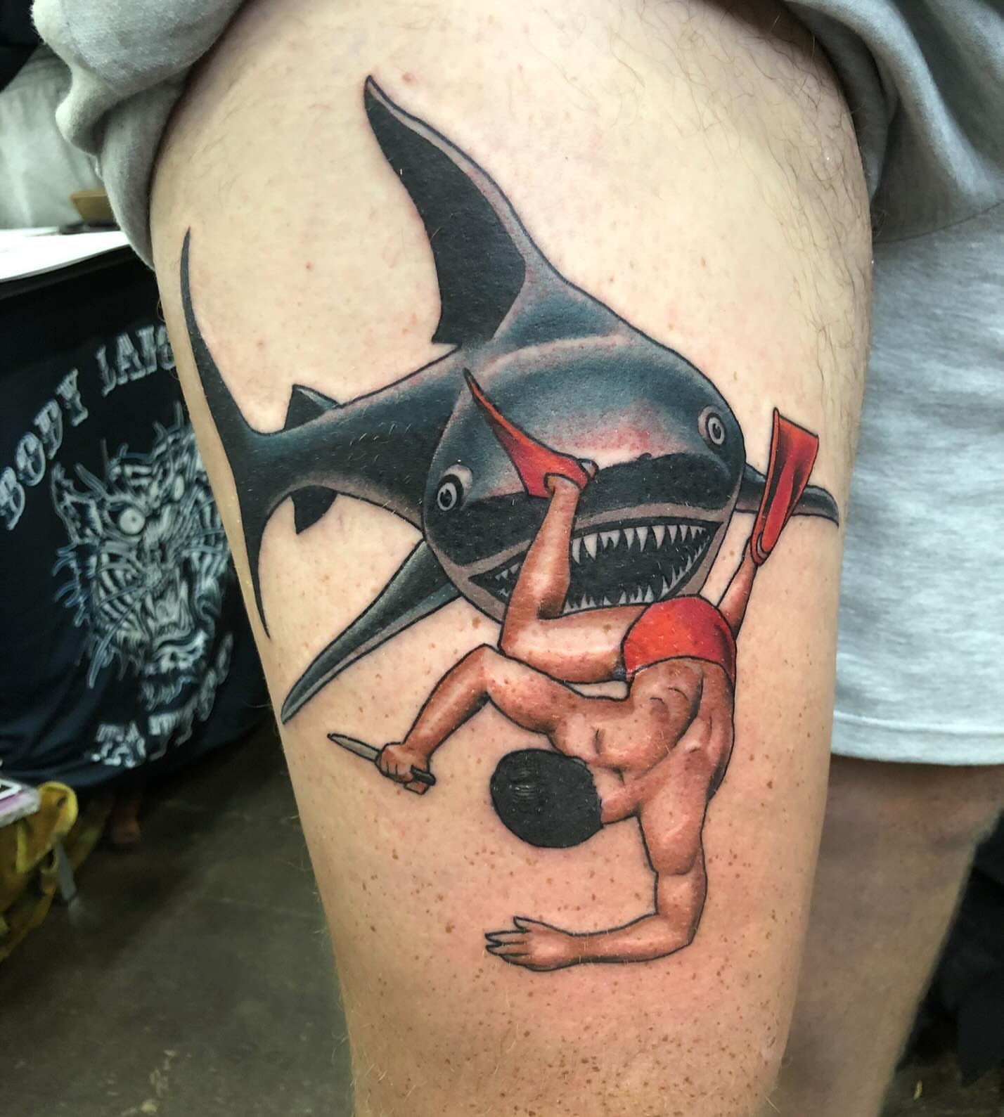 Shark attack scene American traditional tattoo on the thigh by Levi Cox, Powell, Ohio