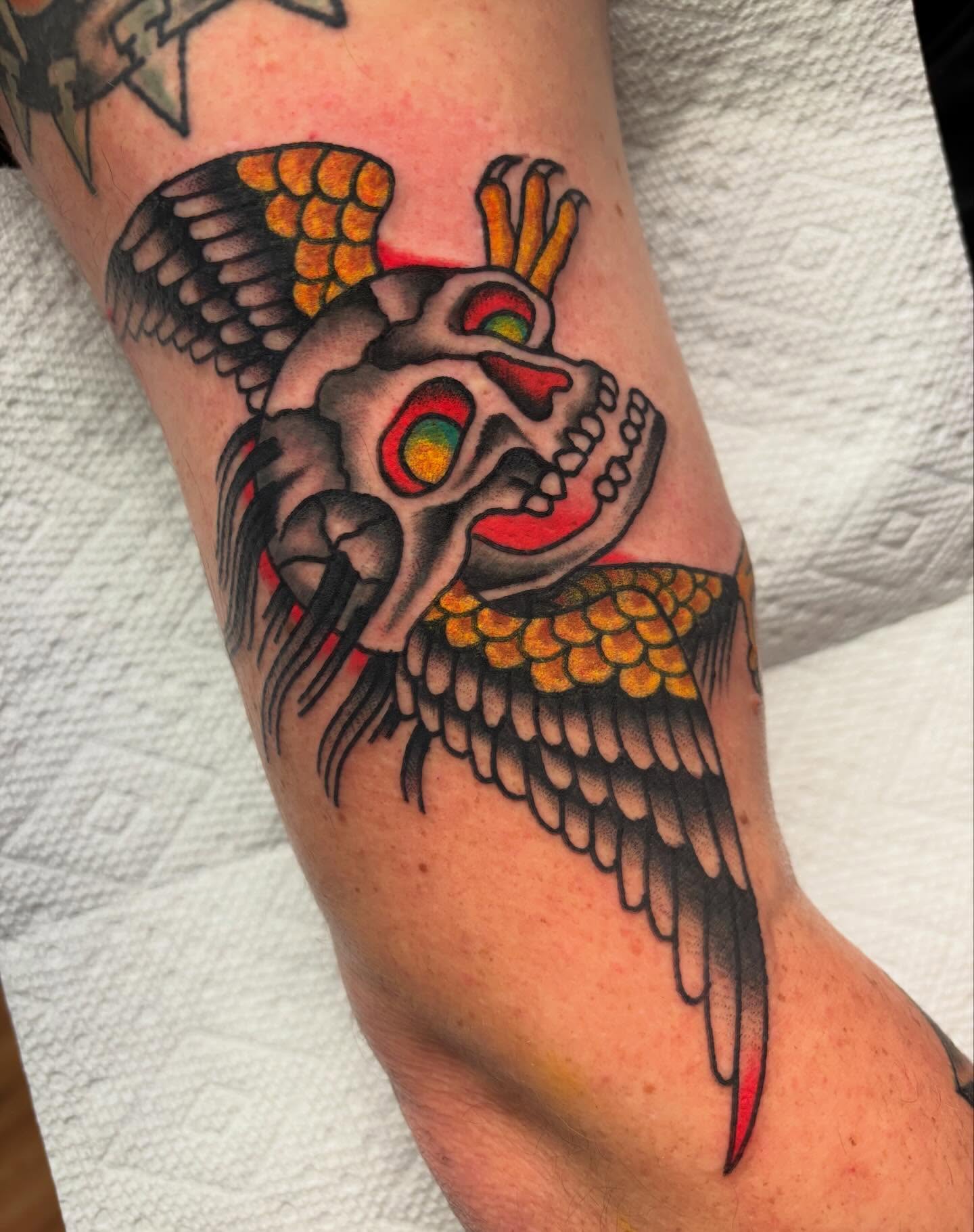 Skull with wings American traditional tattoo on the forearm by Chris Dufresne