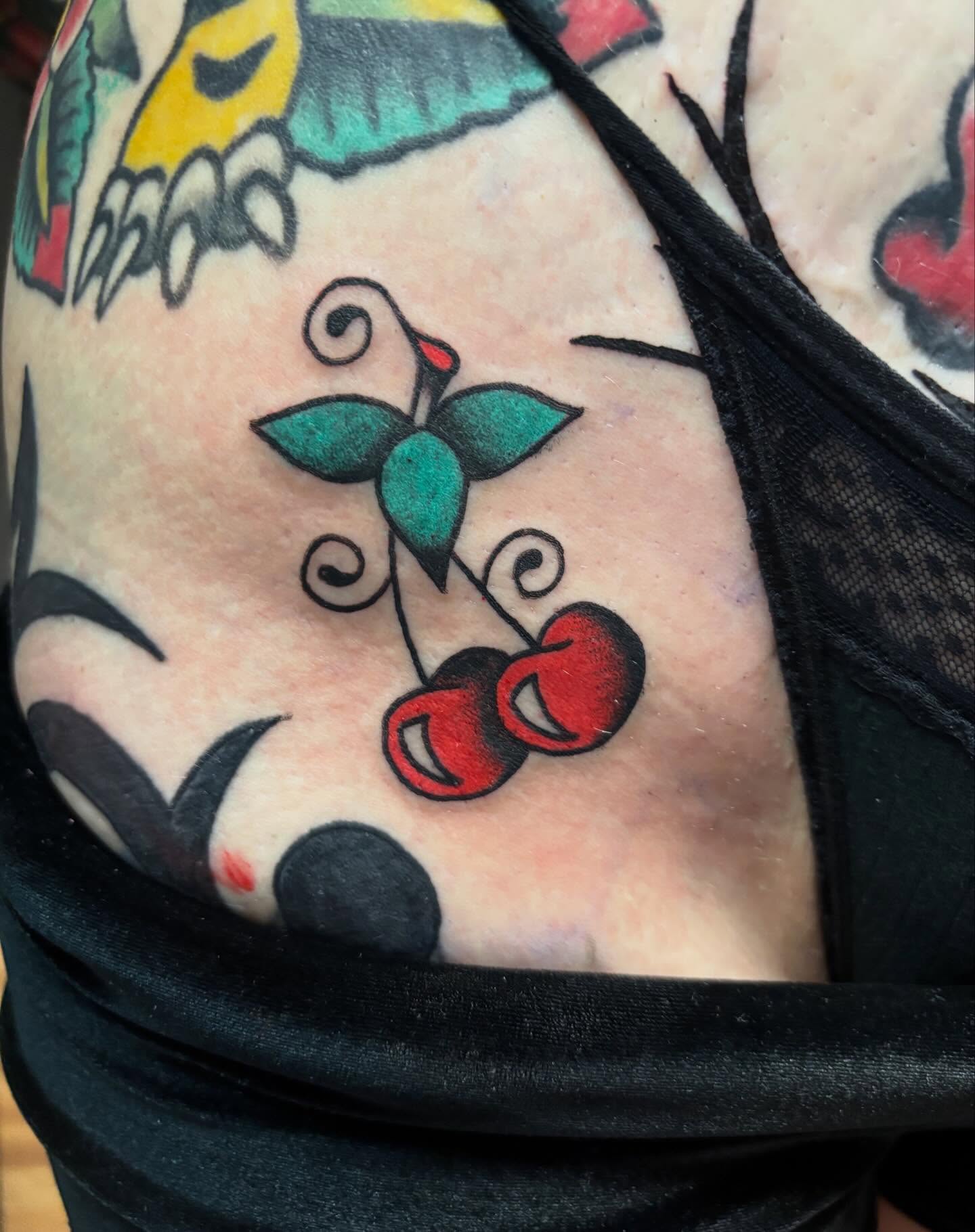 Cherry American traditional tattoo on the shoulder by Chris Dufresne