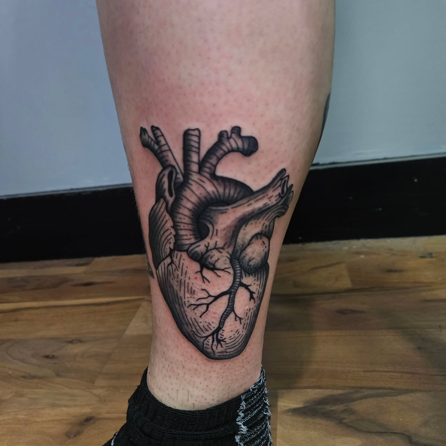 Anatomical heart black and grey tattoo on the calf by Danny