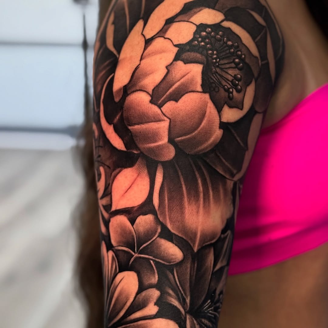 Floral arrangement neo-traditional tattoo on the forearm by Isiah Hall, Whittier, California