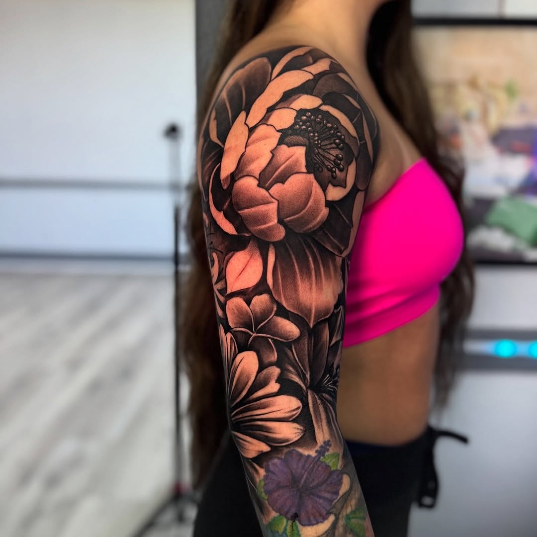Floral sleeve realism tattoo on the upper arm by Isiah Hall, Whittier, California