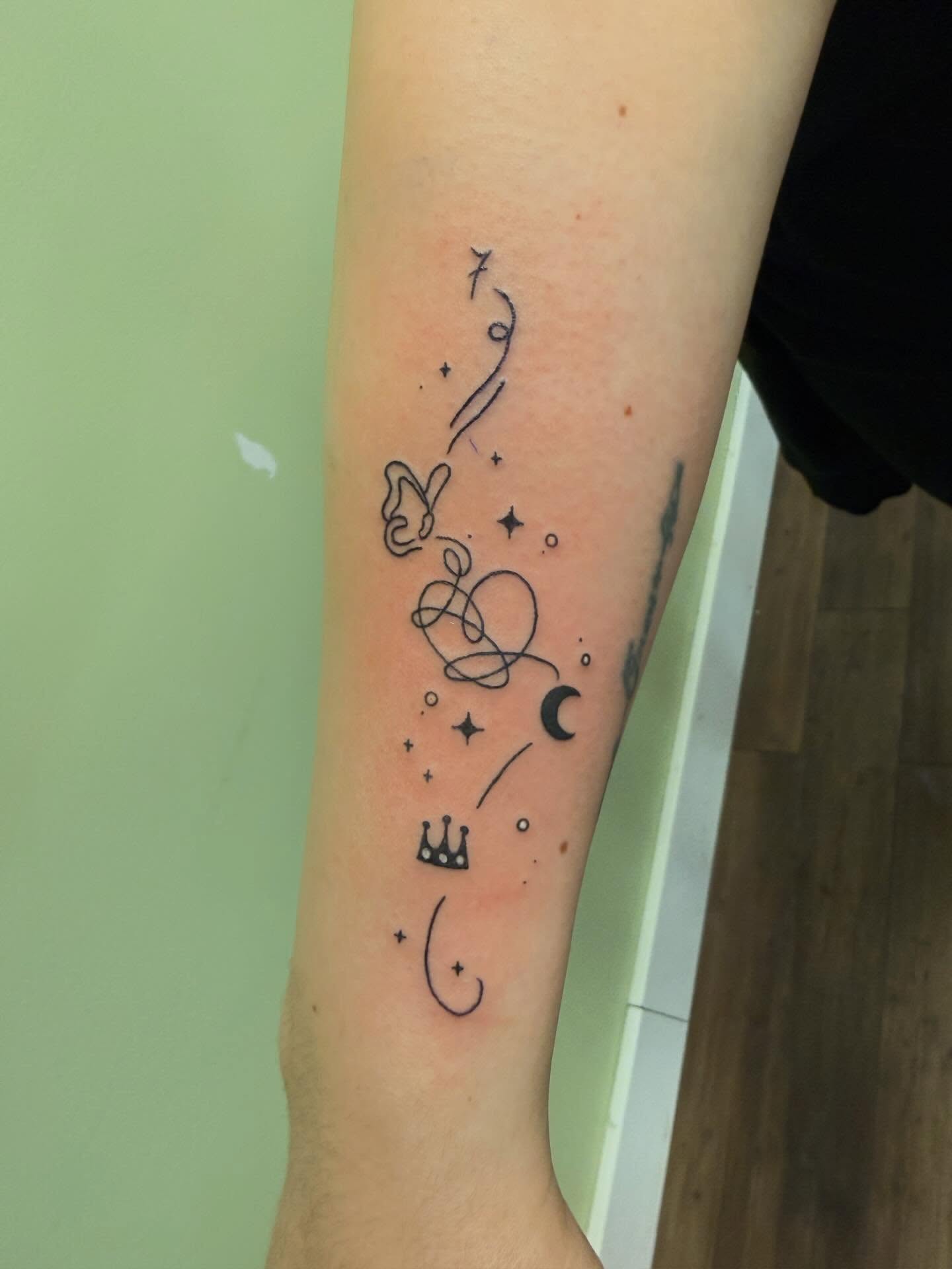 Astronomy symbols fine line tattoo on the forearm by Scout Meyer
