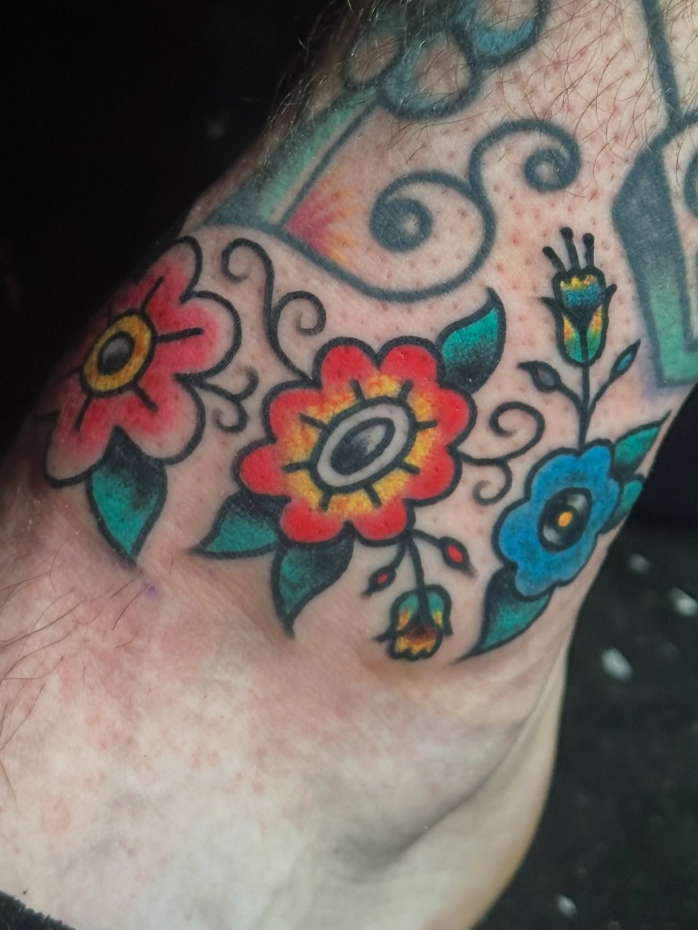 Flowers Chicano tattoo on the forearm by Providence Tattooer