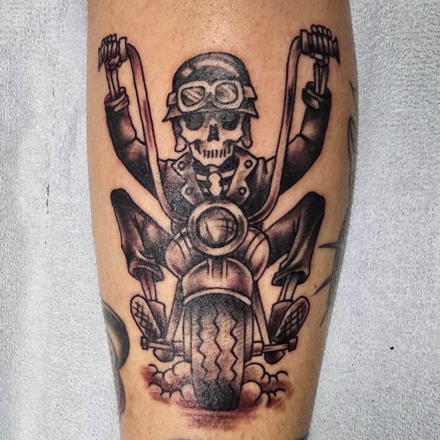 Motorcycle rider skeleton black and grey tattoo on the forearm by bonnie