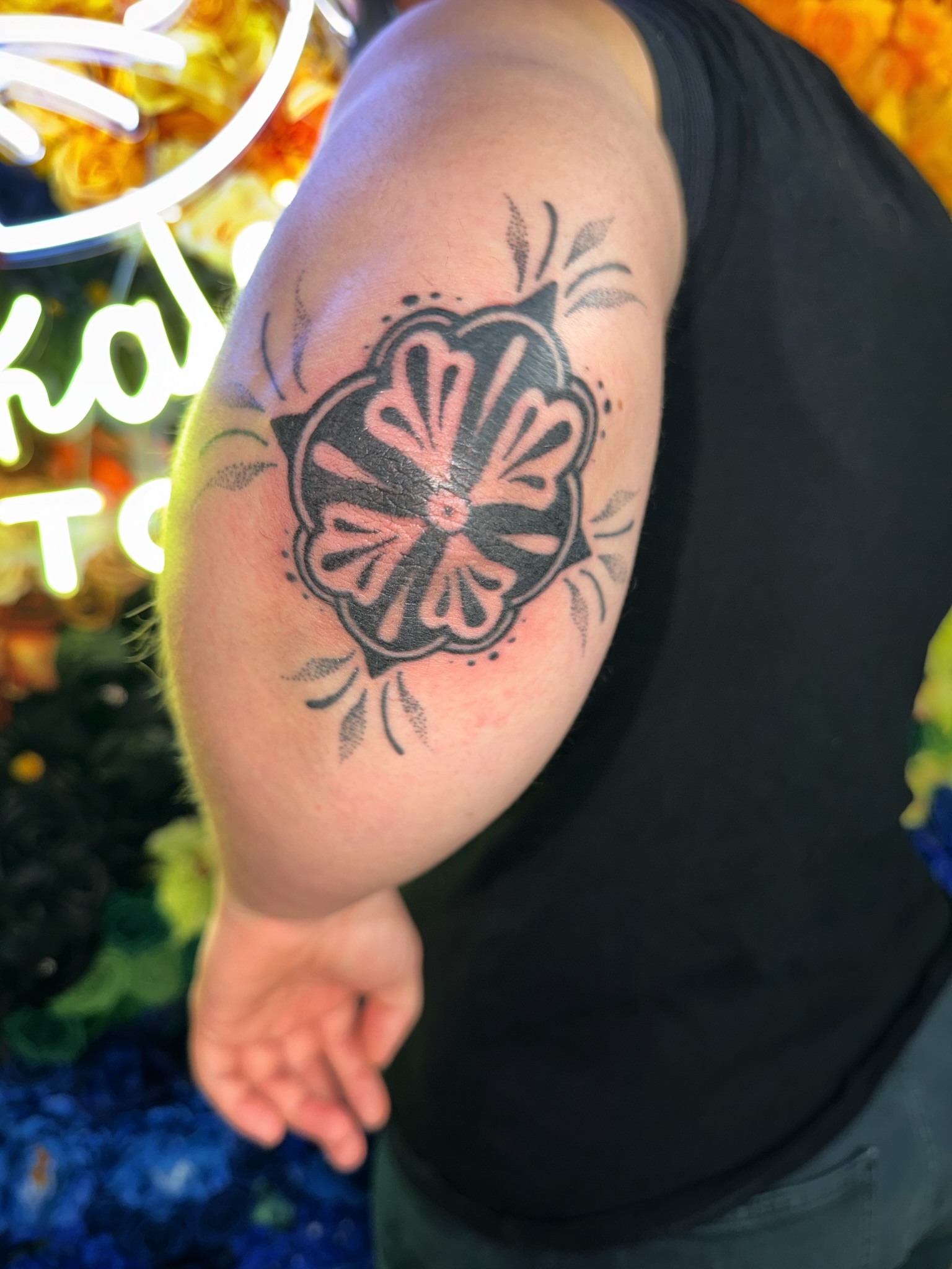 Flower American traditional tattoo on the upper arm by Handpoke Tattoo Artist, Minneapolis, Minnesota