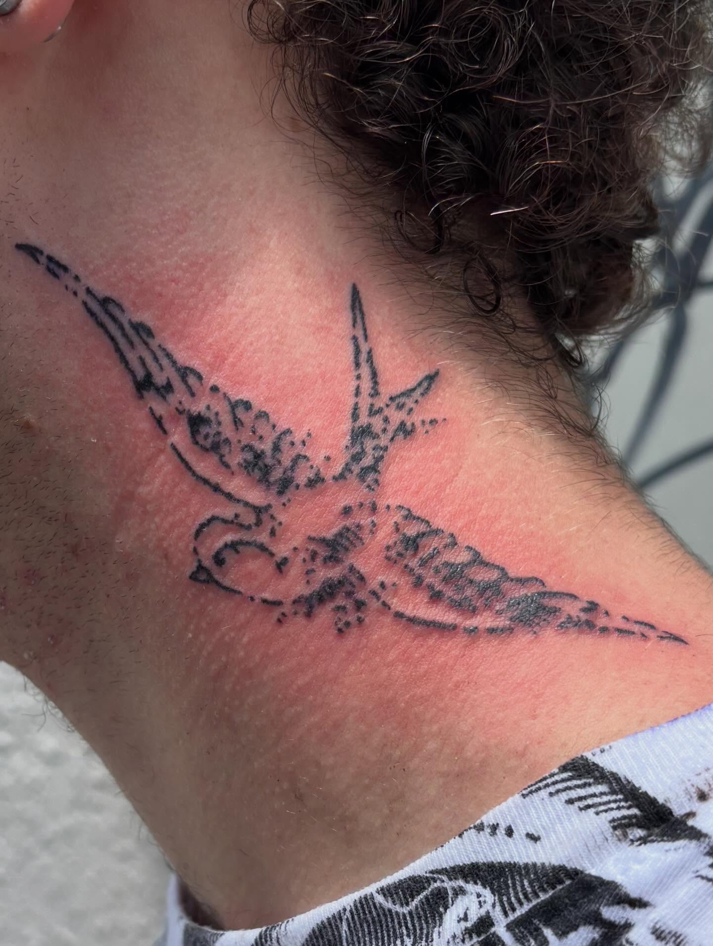 Swallow black and grey tattoo on the neck by Turner