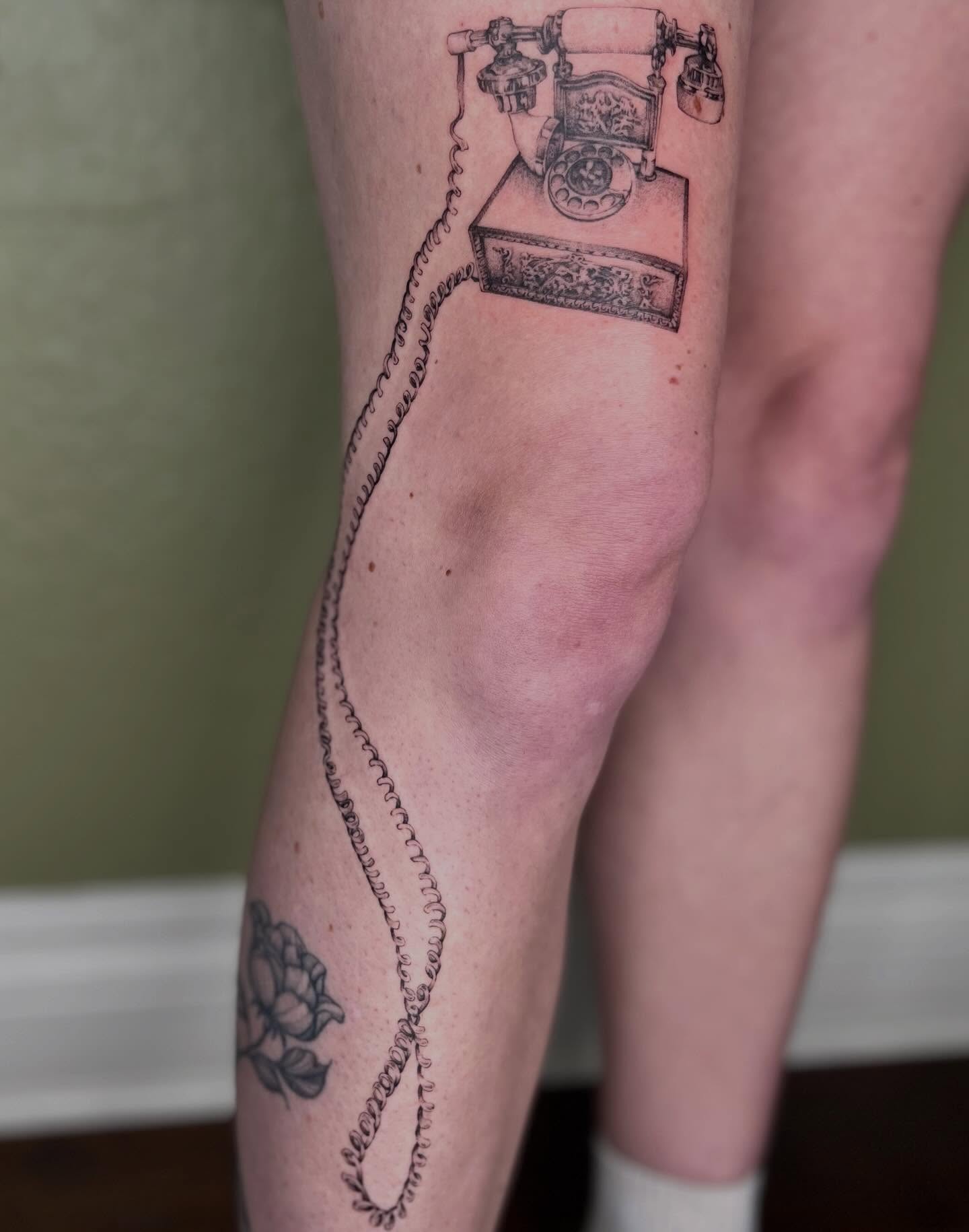 Telephone black and grey tattoo on the calf by Ash F