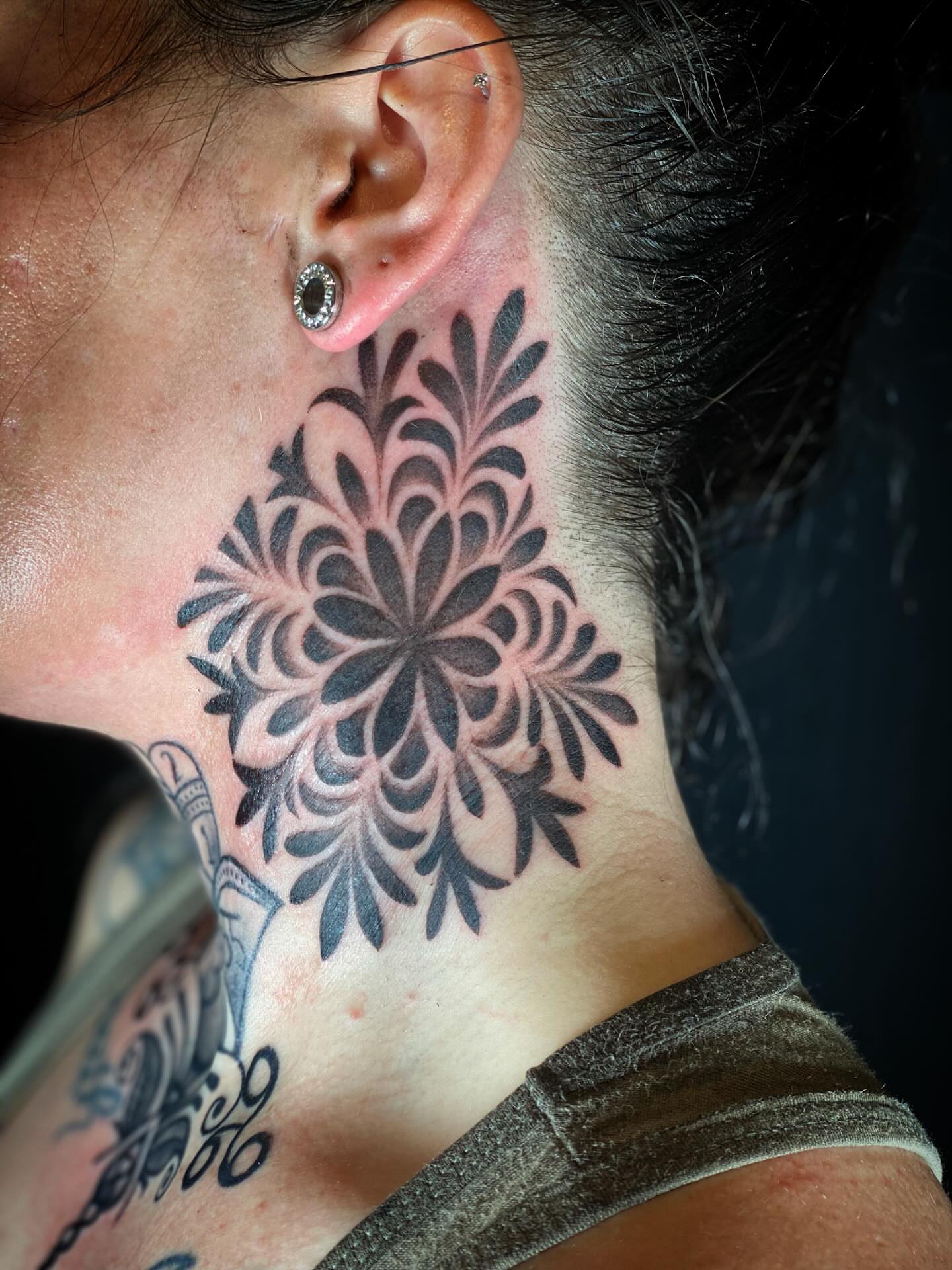 Floral pattern black and grey tattoo on the neck by Chris Klee
