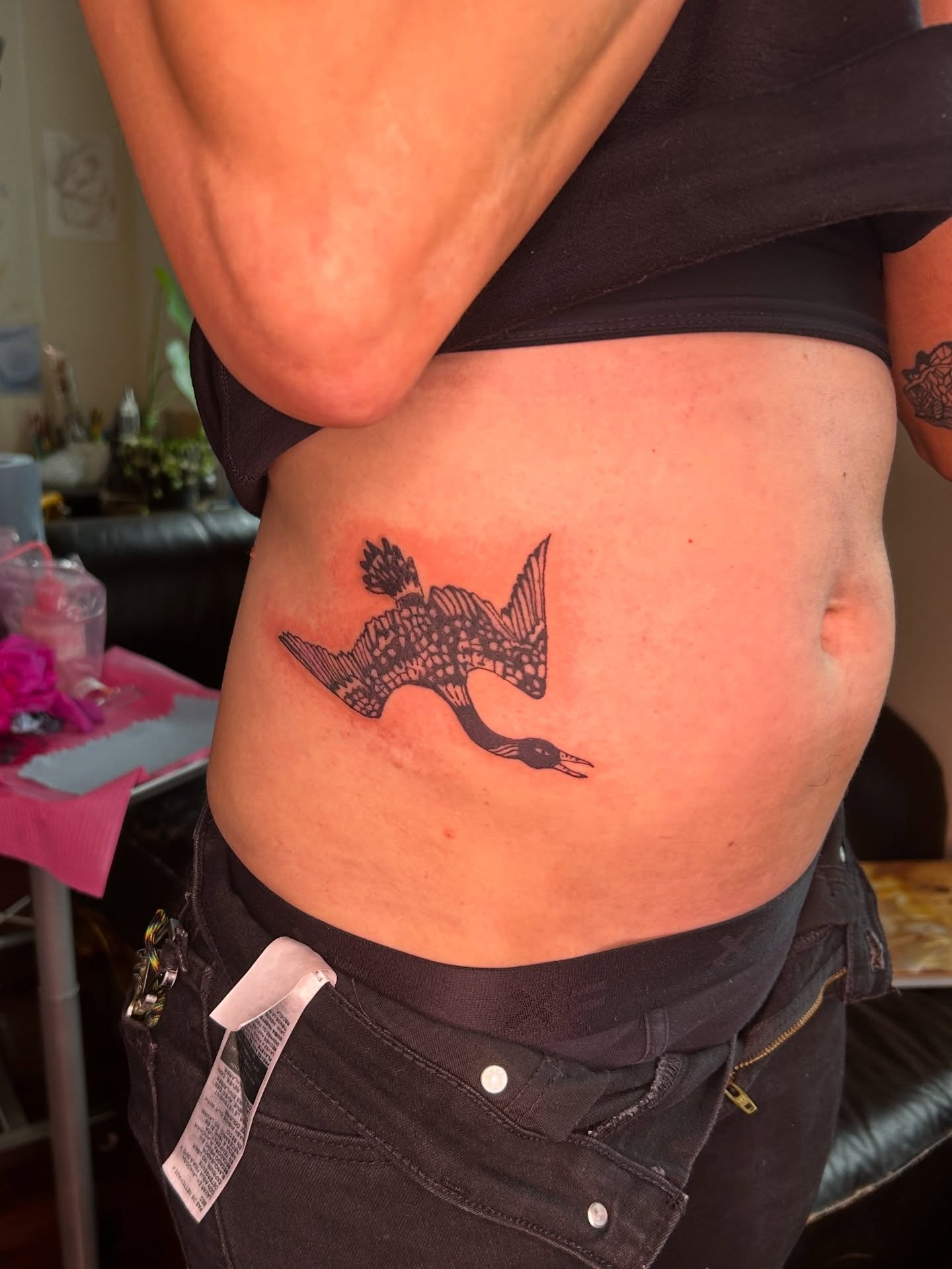 Duck black and grey tattoo on the torso by Mattie Robinson