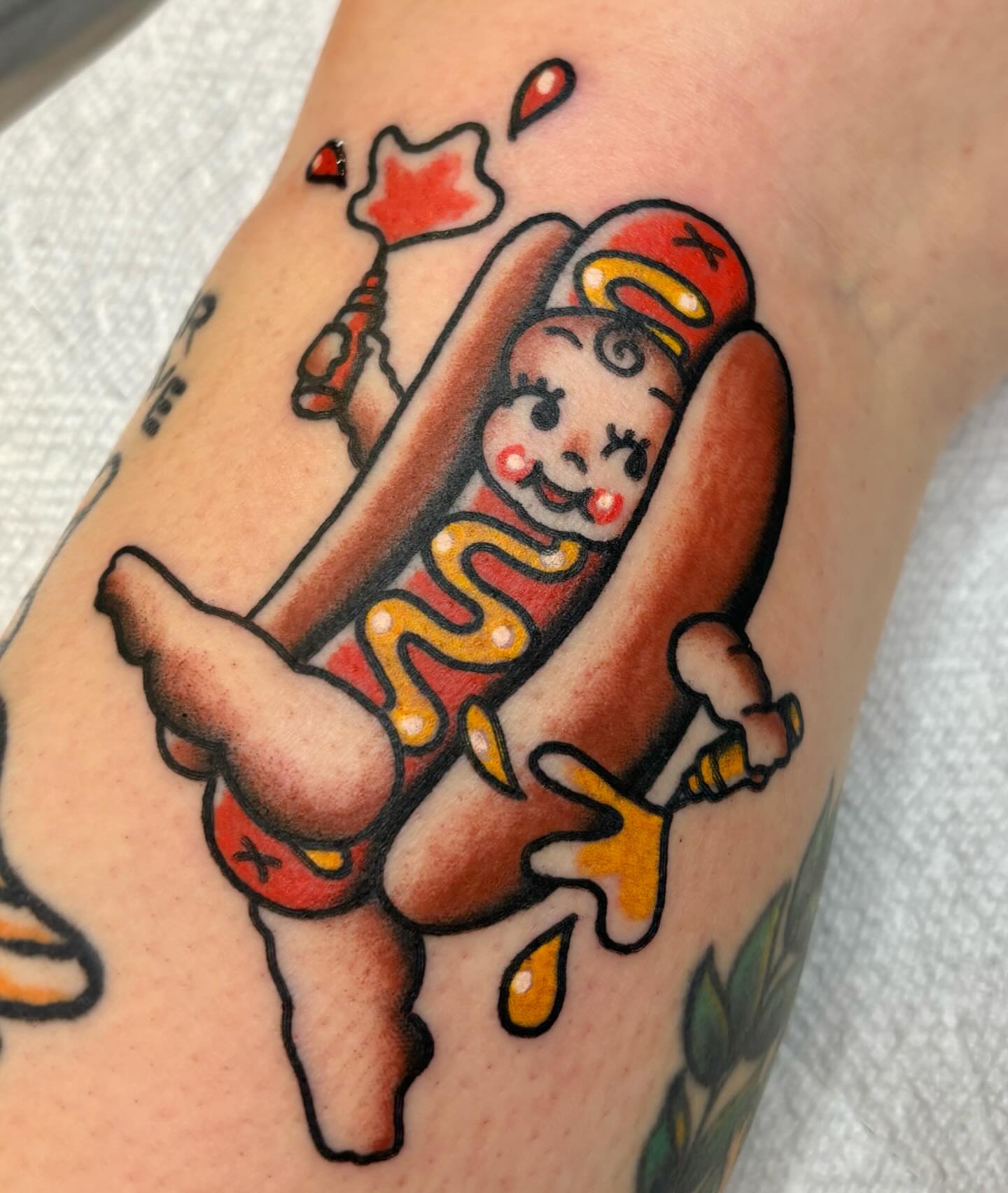 Hot dog character American traditional tattoo on the forearm by @rutattoos