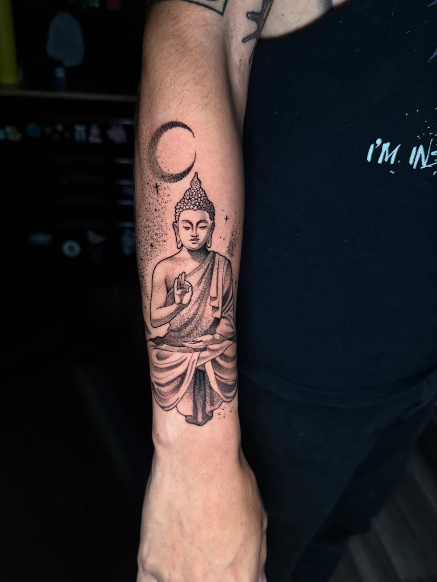 Buddha statue dotwork tattoo on the forearm by Mads Ink