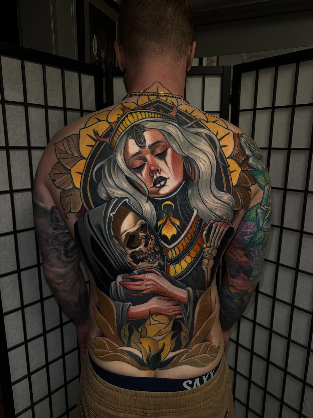 Woman embracing a skeleton neo-traditional tattoo on the back by Matt - Neotrad Tattoos, New York, New York