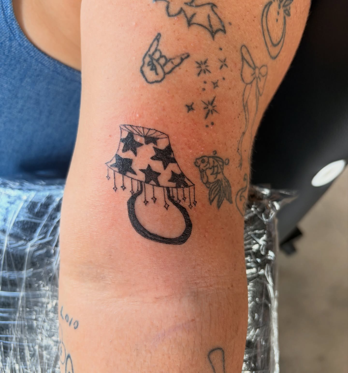 Hat with stars black and grey tattoo on the forearm by Inky Birdz Tattoos