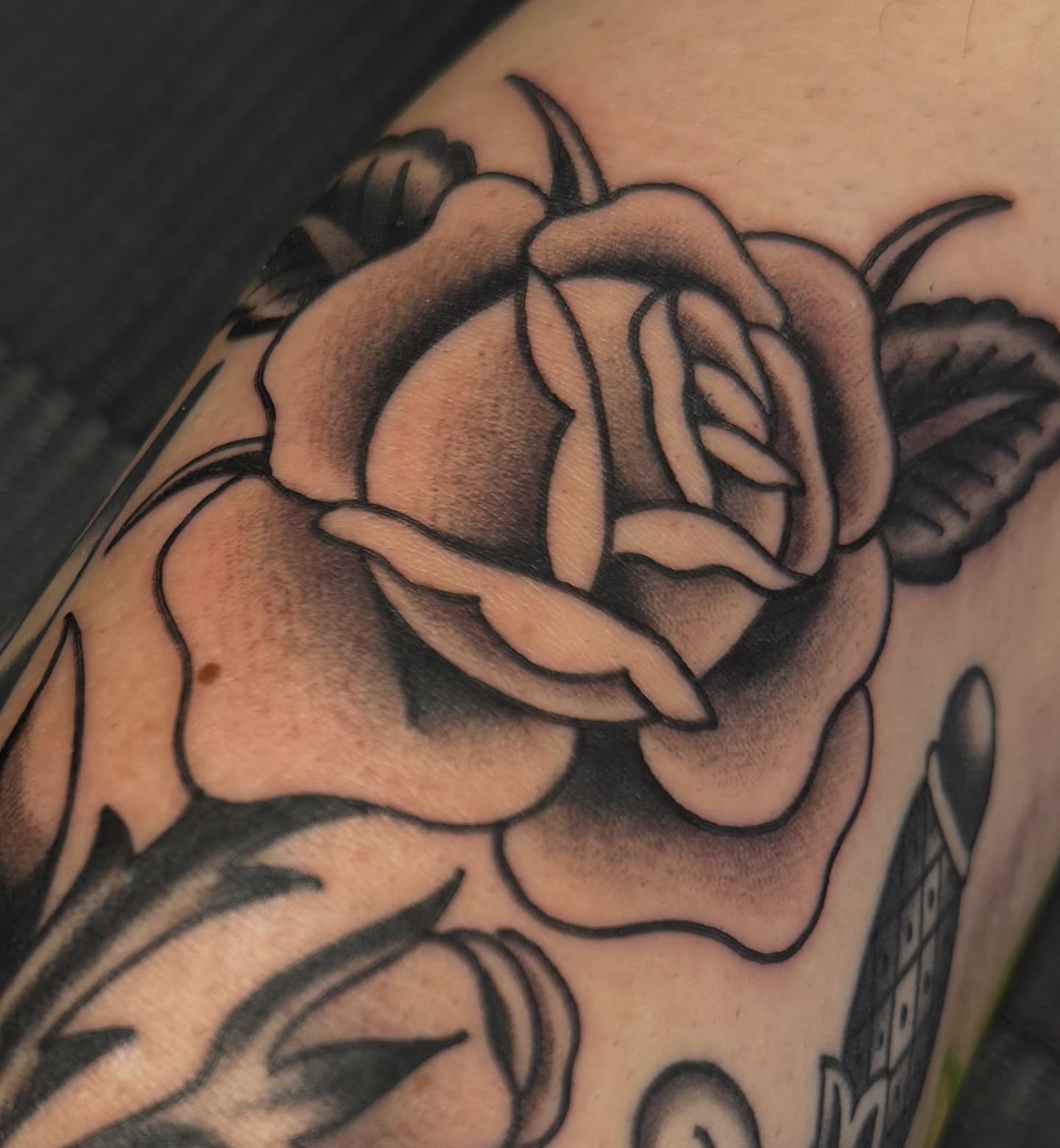 Rose black and grey tattoo on the forearm by Kaley, Des Moines, Iowa