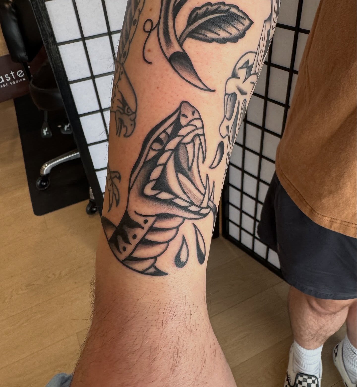 Snake black and grey tattoo on the forearm by Kaley, Des Moines, Iowa
