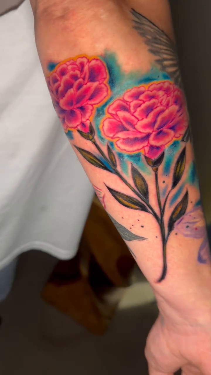 Three pink peonies with blue background neo-traditional tattoo on the forearm by spikecitytattoo