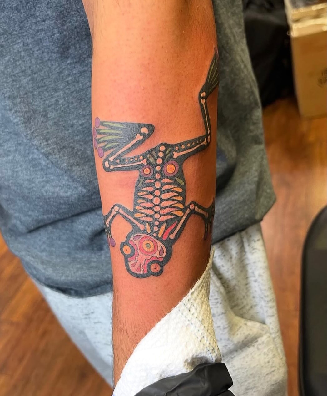 Frog skeleton dotwork tattoo on the forearm by Cohen