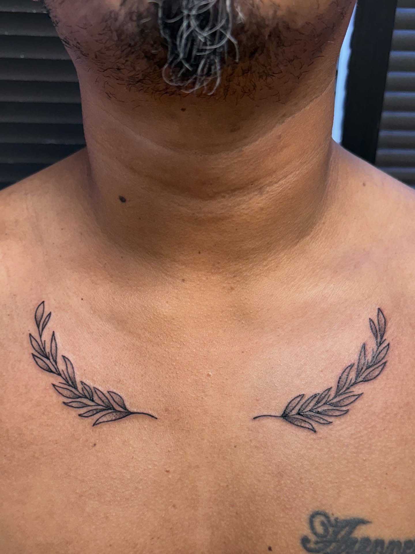 Wreath black and grey tattoo on the chest by Royal Martinez