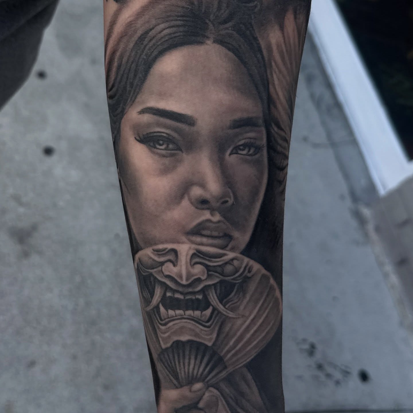 Woman with mask realism tattoo on the forearm by Kiefer Fonseca