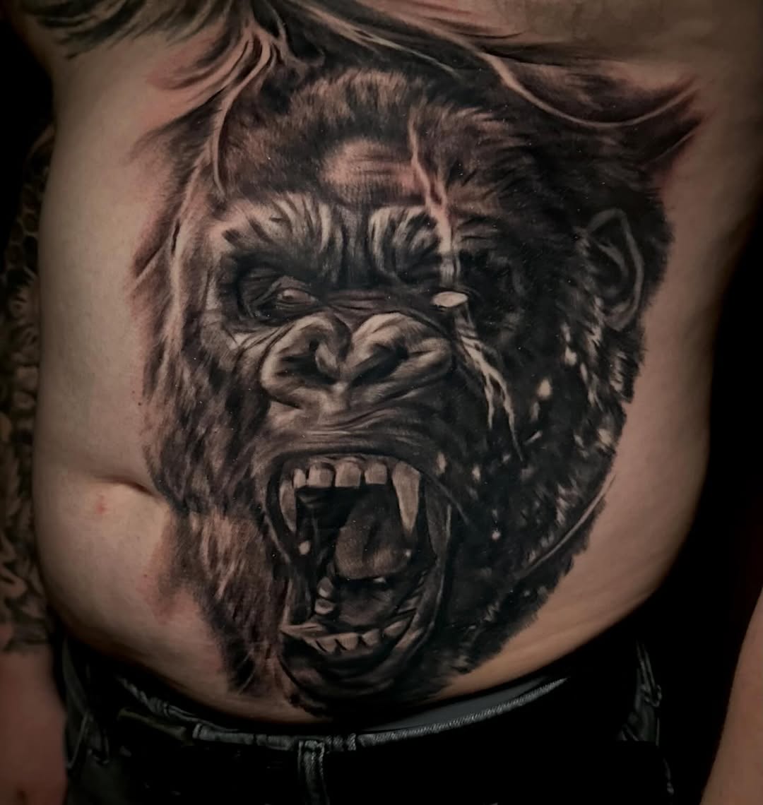 Gorilla portrait realism tattoo on the chest by Comfy Chris Fettig