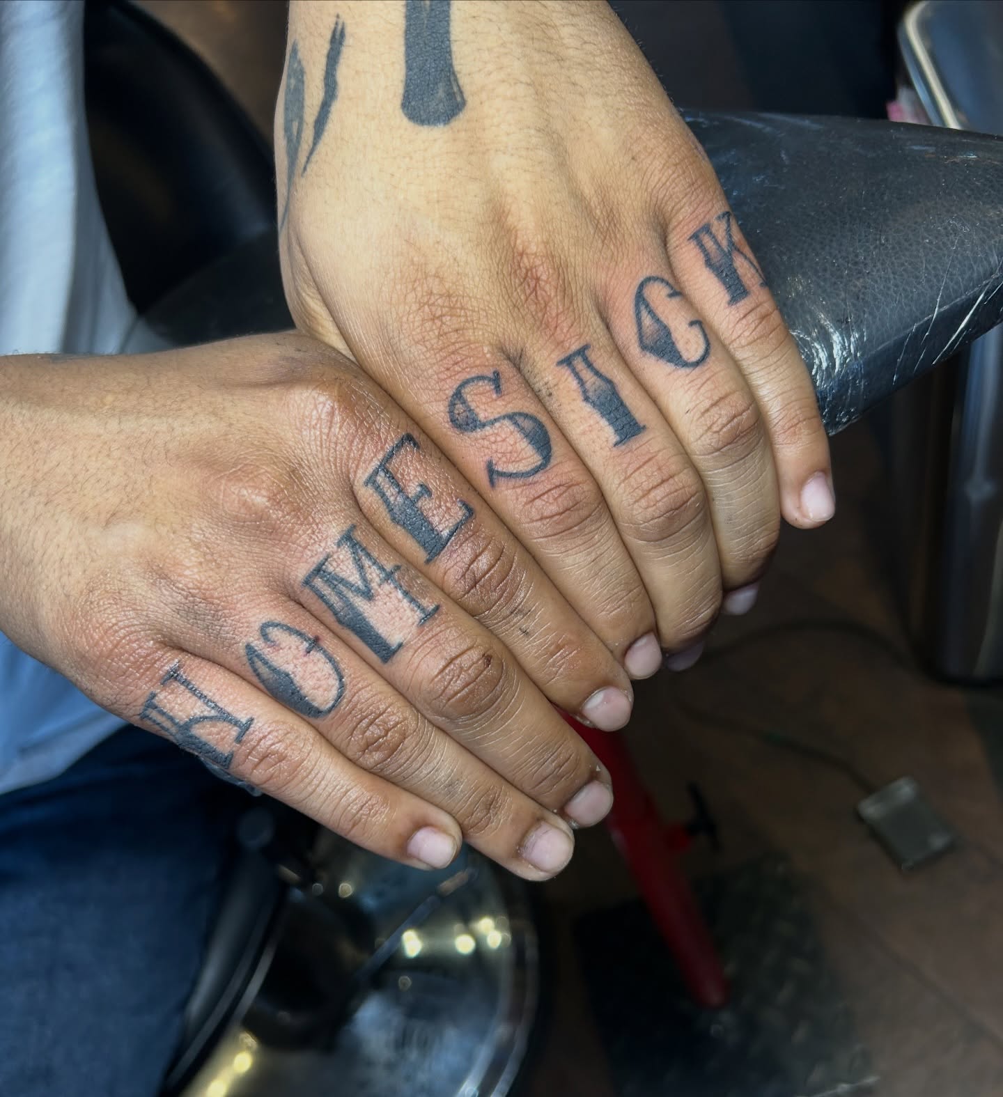 Homesick lettering script tattoo on the hand by Tattoos by Corey aka MrLu